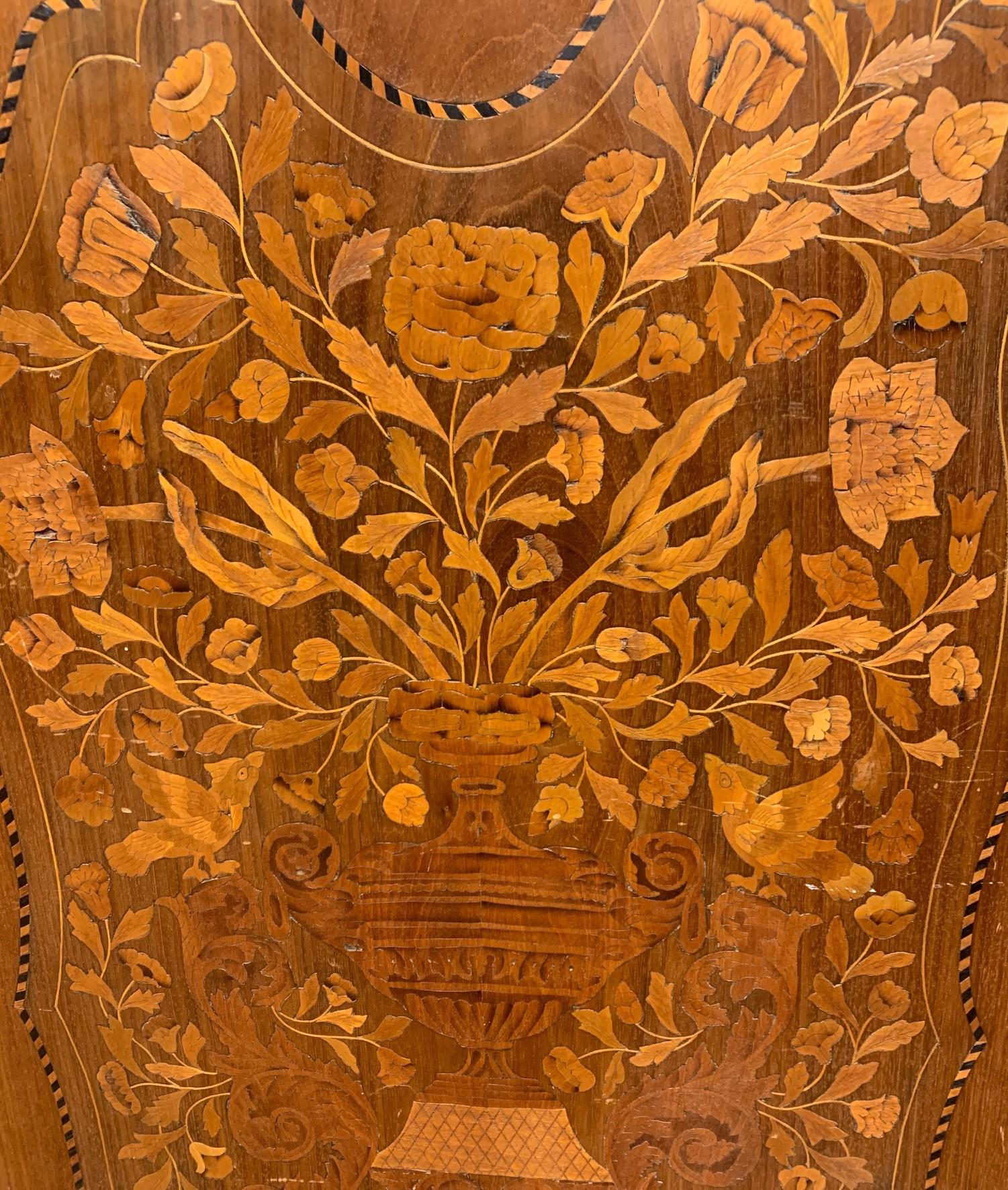 Wonderful 19th century pair of Dutch walnut wall panels with contoured crests. Featuring fine marquetry inlays of olivewood, pearwood, and satinwood depicting elaborate floral arrangements and classical urns,

circa 1890.