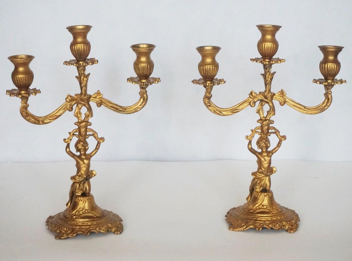 A pair of gilt bronze three-light candelabra with kneeling putto holding the candleholders raised on richly elaborate base, France, late 19th century.
Measures:
Height 12.50 in / 31.5 cm
Width 9.50 in / 24 cm.



   