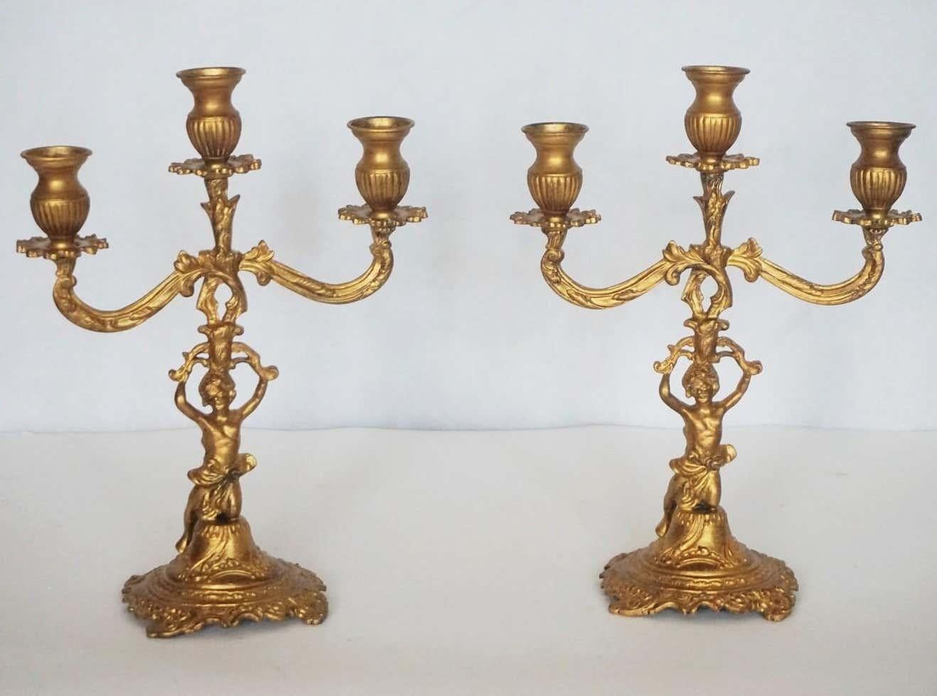 A pair of gilt bronze three-light candelabra with kneeling putto holding the candleholders raised on richly elaborate base, France, late 19th century.
Measures:
Height 12.50 in / 31.5 cm
Width 9.50 in / 24 cm.