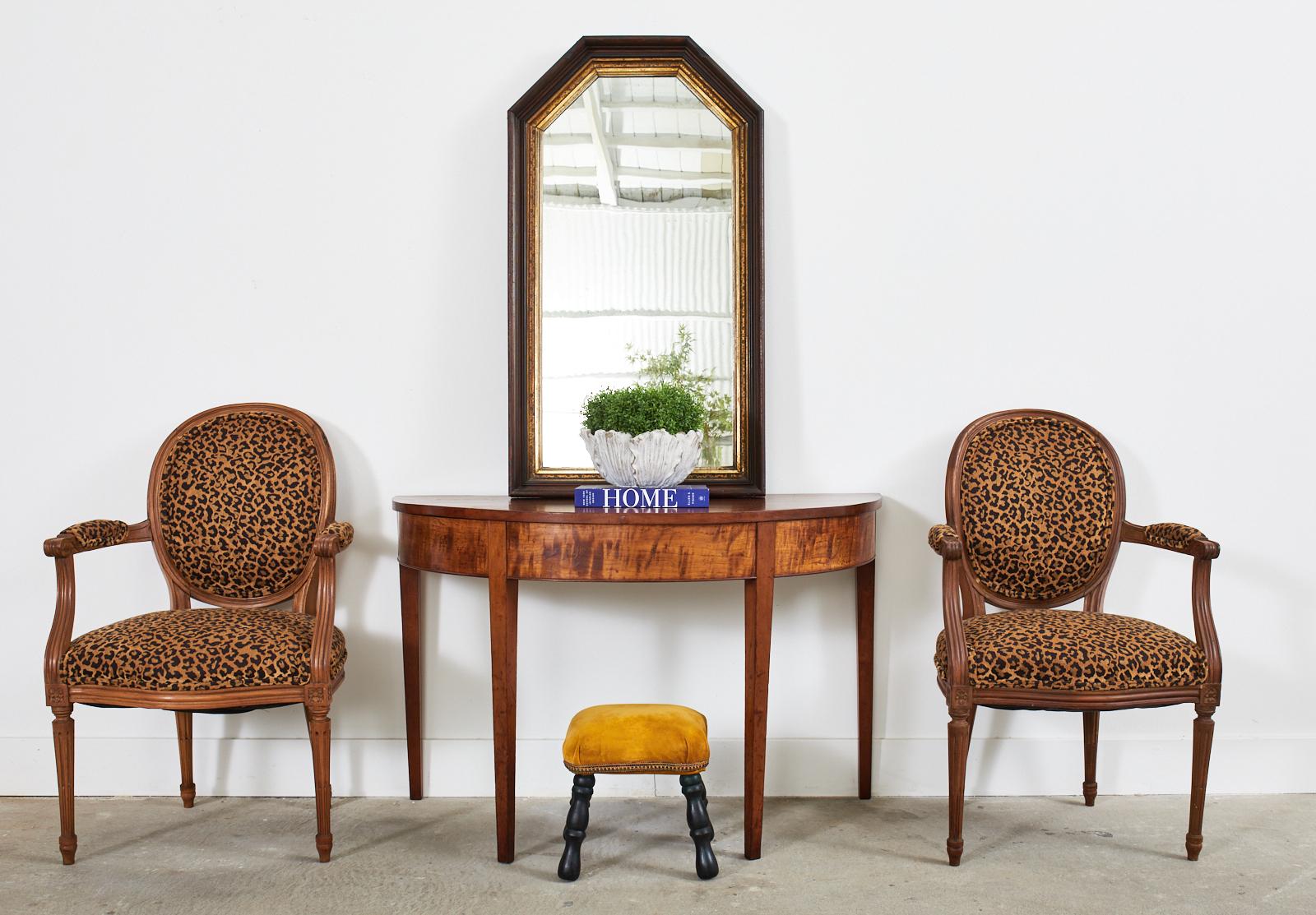 Gorgeous pair of 19th century English demilune console tables or center table crafted from radiant mahogany. Originally ends of a grand refectory table made in the elegant George III taste. The pair of consoles are elegant with a simple design