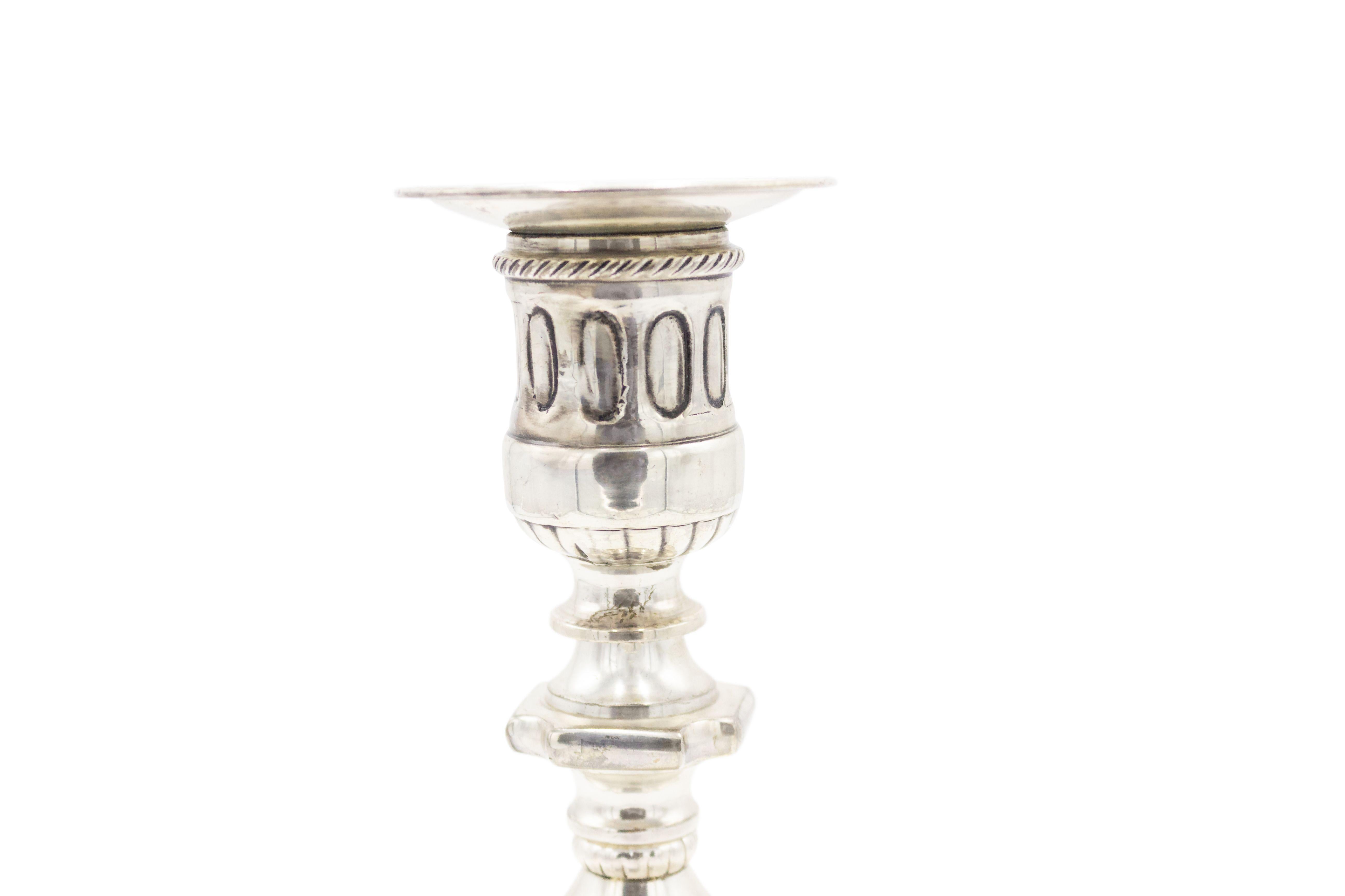 Pair of English Georgian-style (19/20th Cent) silver-plate candlesticks with a festoon design and round base.