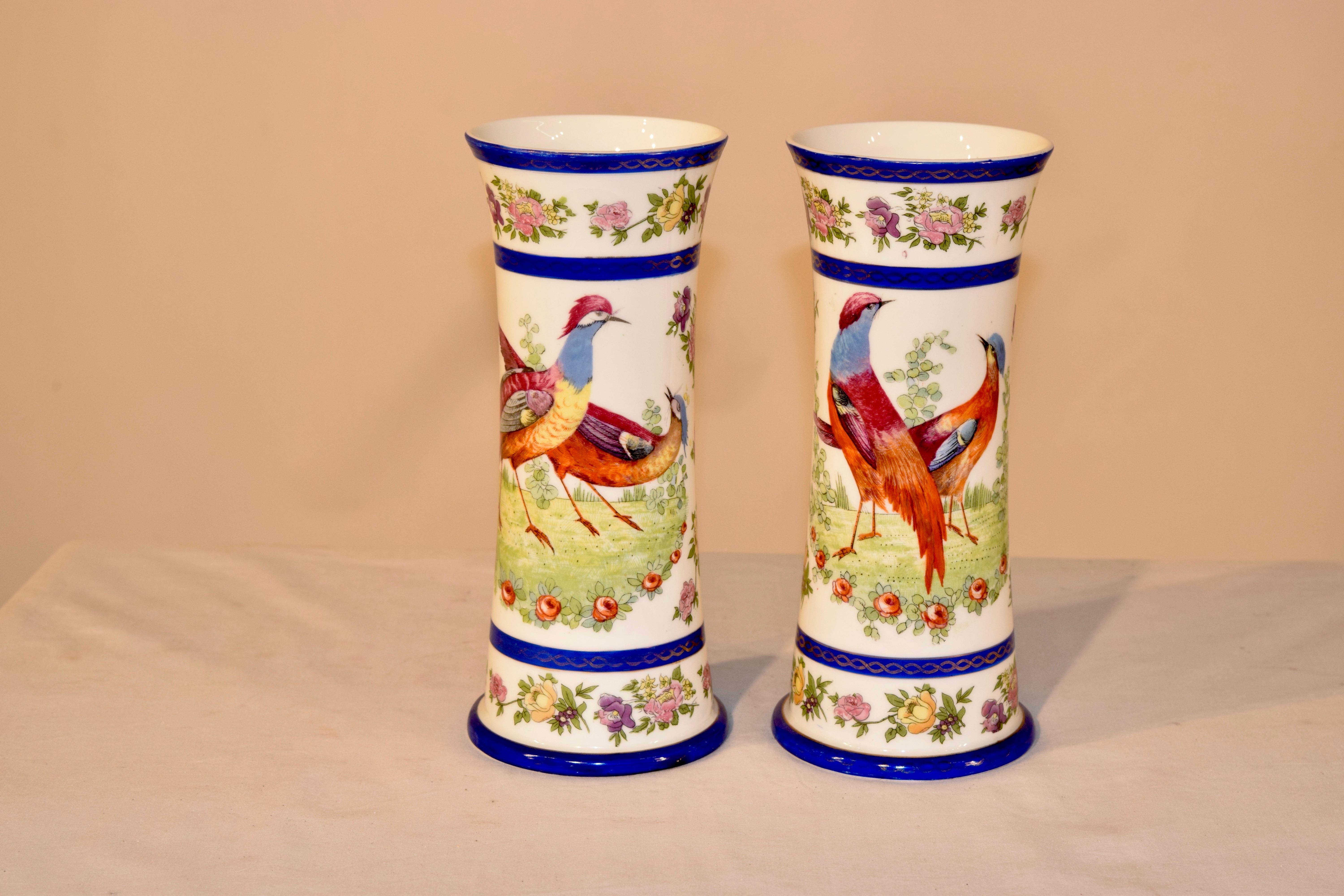19th century pair of lovely cylindrical shaped vases with hand painted decoration of birds and florals and striking borders in cobalt blue.