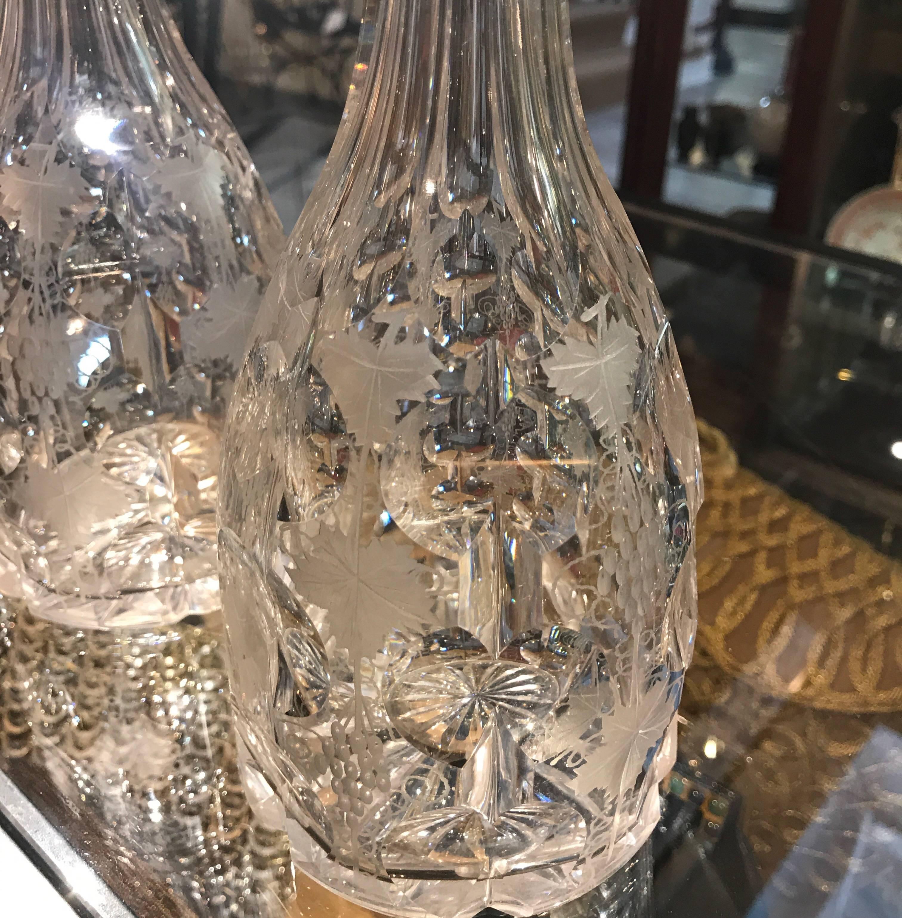 An original pair of 19th century cut-glass wine decanters with deep cuts and an etched fruit vine decoration. Fruiting Vine is an amazing cut with a long history. Variations of Fruiting Vine have been produced by Walsh, Webb, Edinburgh Crystal,