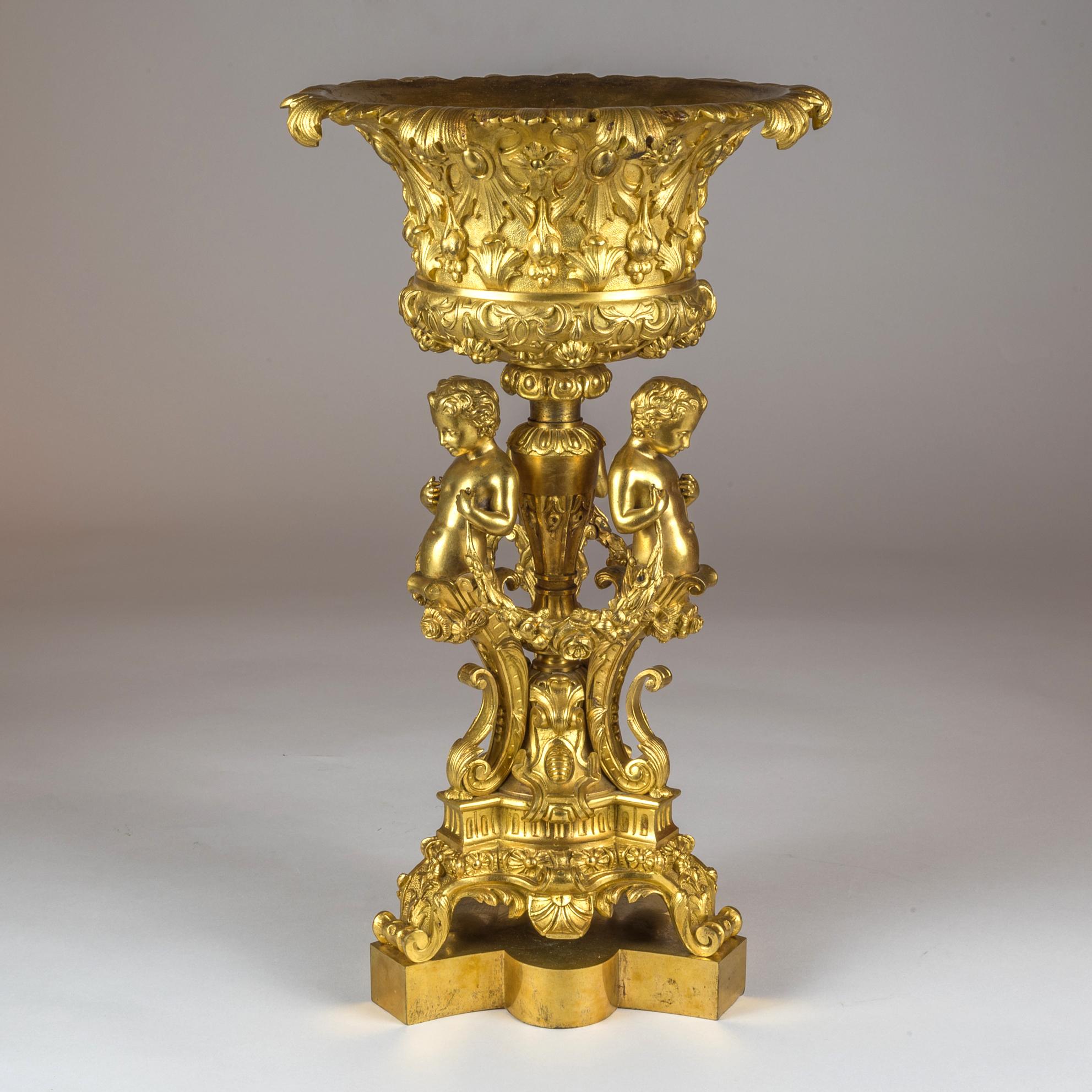 An elaborate pair of 19th century figural gilt bronze tazzas supported by Three Cherubs

Origin: French
Date: circa 1860
Dimension: 16 1/4 in x 9 1/2 in.