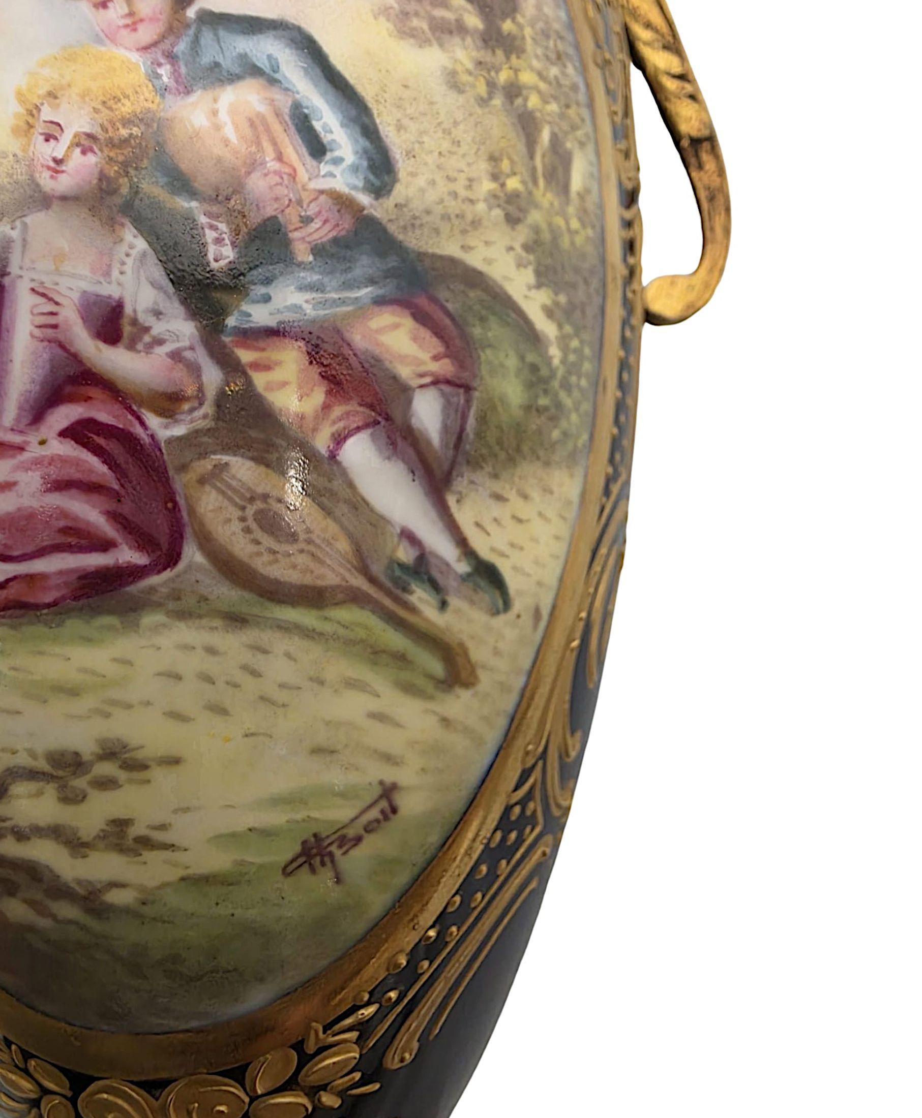 A very fine pair of 19th Century hand painted porcelain lidded urns in the Sevres manner of exceptional quality and ormolu mounted with elaborately painted decorative golden detail against royal blue ground throughout.  This fabulous pair feature