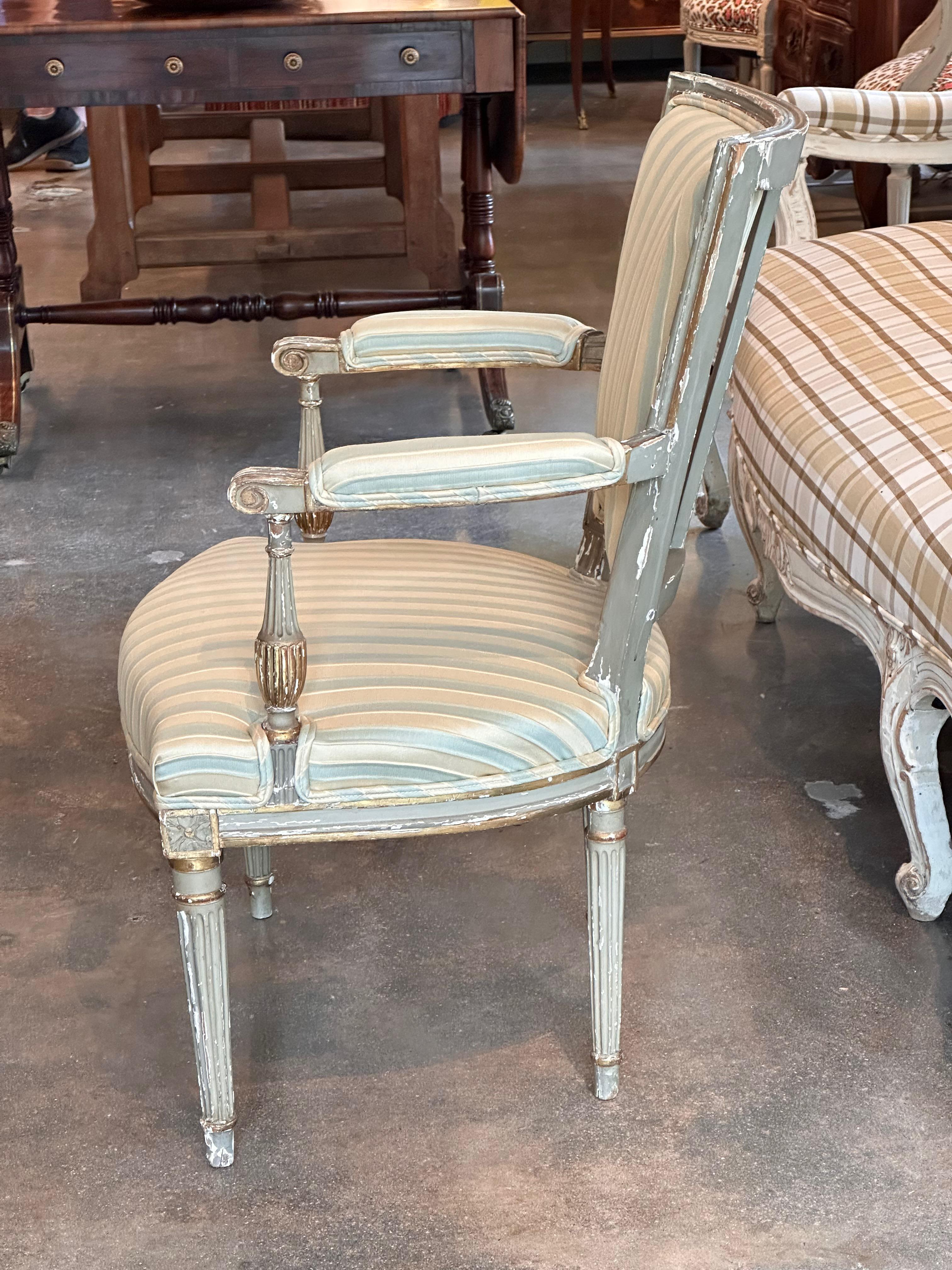 Nice pair of French arm chairs. Gilding and gray paint