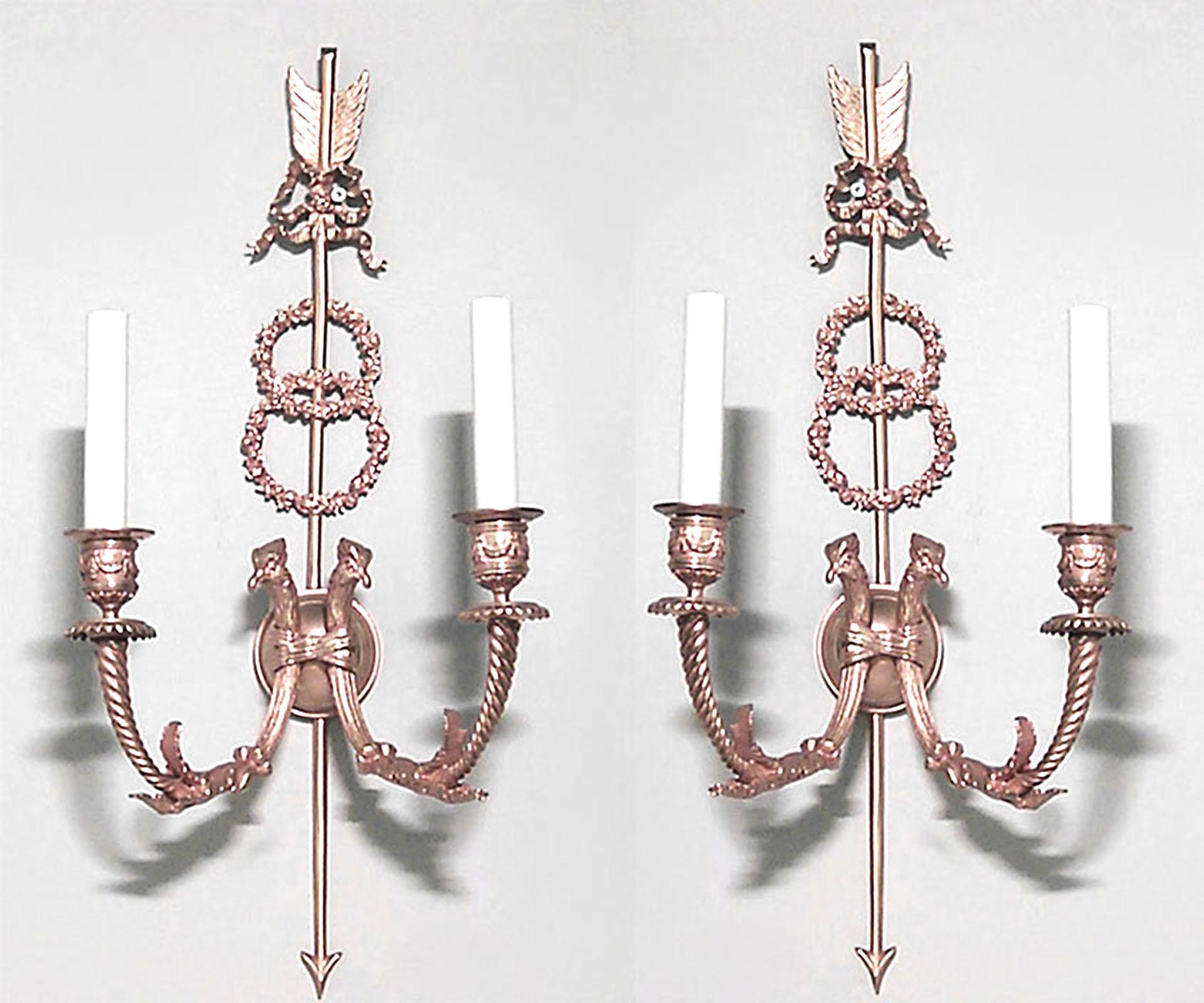Pair of French Directoire-style (19th Century) bronze dore wall scoces with two arms, a double wreath design, and bird head and arrow details. (PRICED AS Pair).
 
