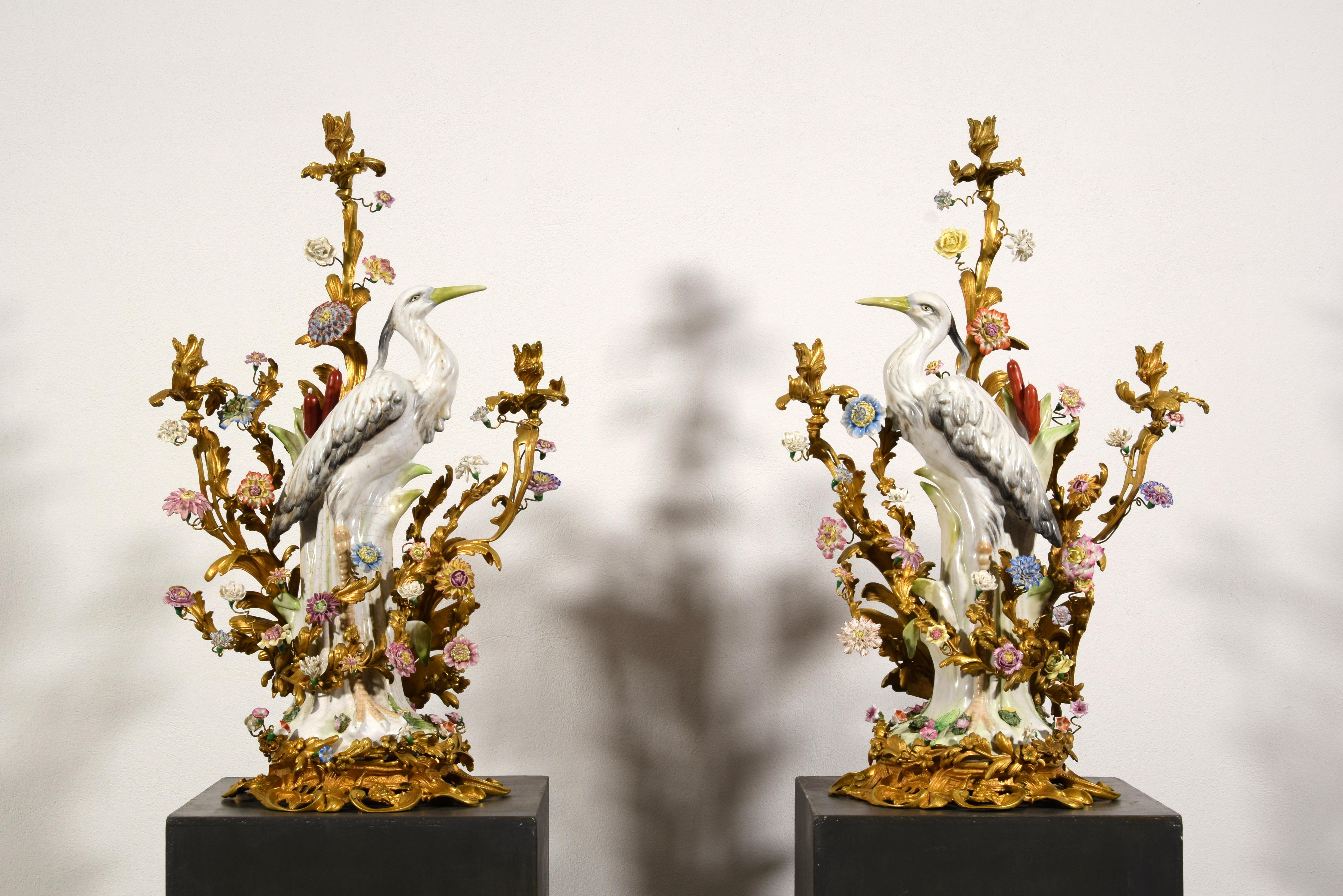 19th Century Pair of French Large Gilt Bronze and Porcelain Candelabras 
Dimensions: cm H 82 x W 50 x D 34. Base 35 x 34 cm

This pair of large candelabras was made in France in the 19th century from chased and gilded bronze, adorned with heron