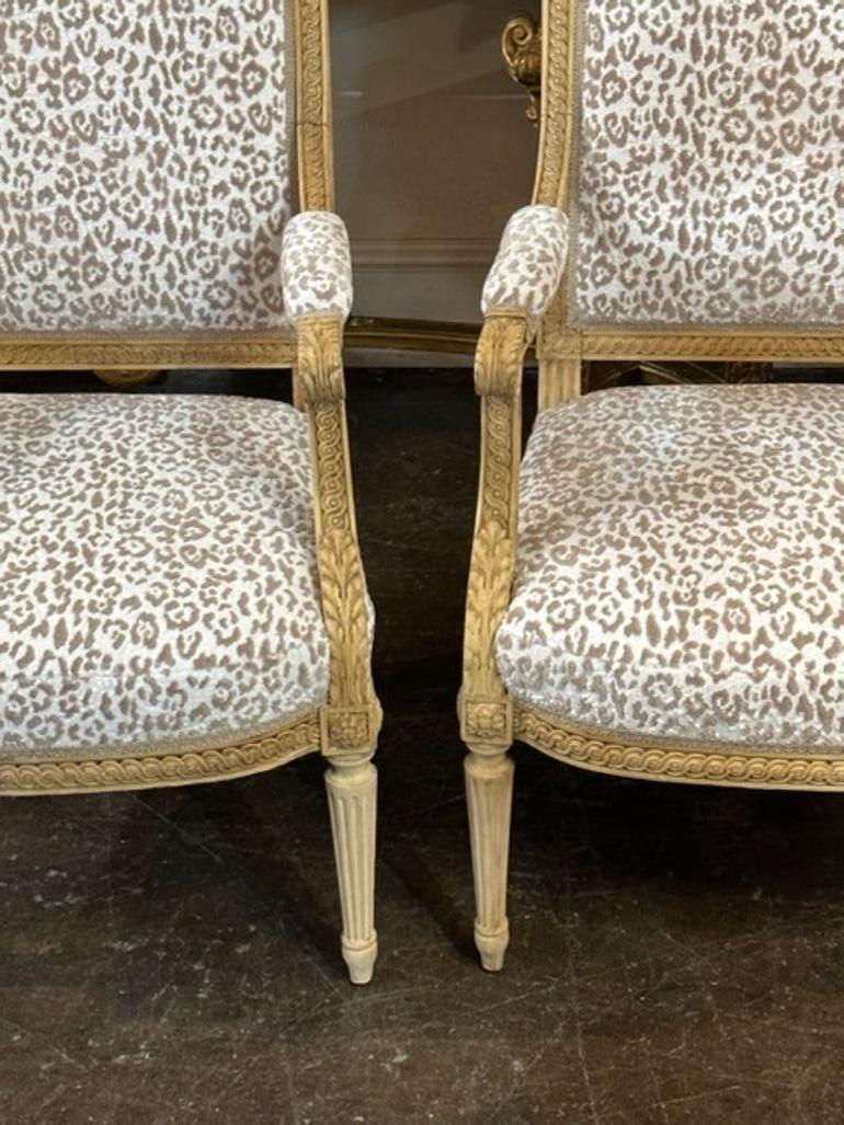 Fabulous pair of 19th century French Louis XVI carved and bleached side chairs. Upholstered in creme and tan animal print and beautiful carvings as well. Makes an elegant statement!