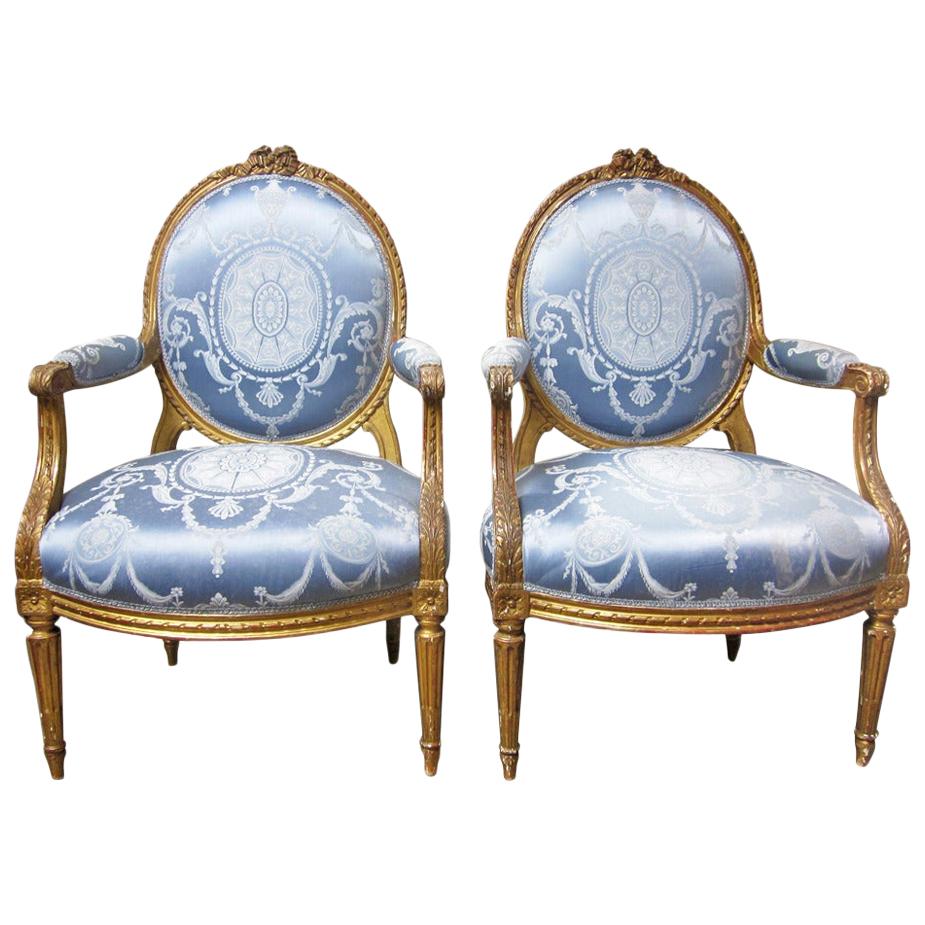 19th Century Pair of French Louis XVI Style Armchairs with a Gold Leaf Finish For Sale