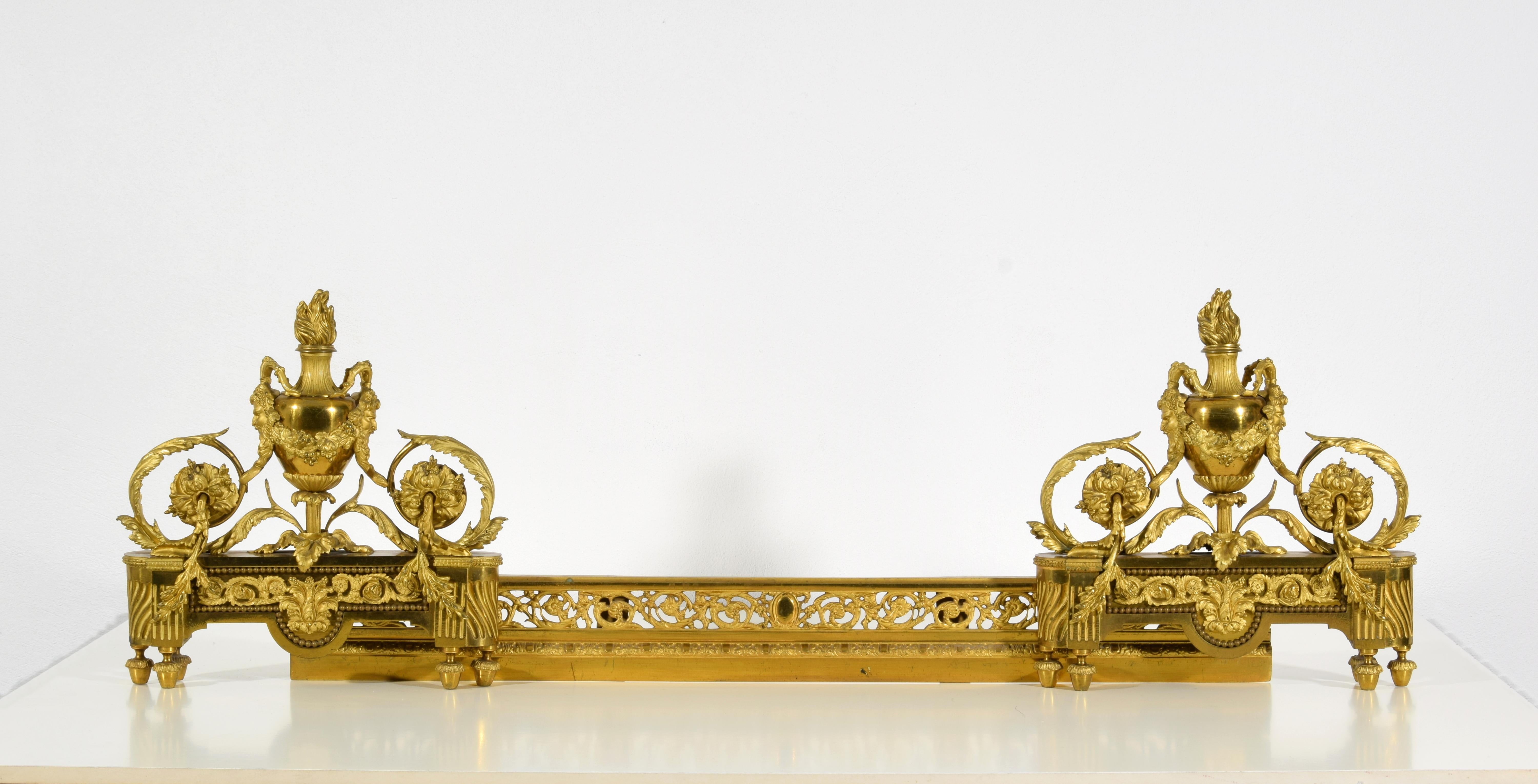 Paar französische Kamin- Chenets aus vergoldeter Bronze im Louis-XVI.-Stil des 19. Jahrhunderts 
Maße: geschlossen: cm B 97 x H 34 x T 12; B maximal offen cm 144,5

Dieses elegante Kaminbesteck wurde im 19. Jahrhundert in Frankreich aus fein