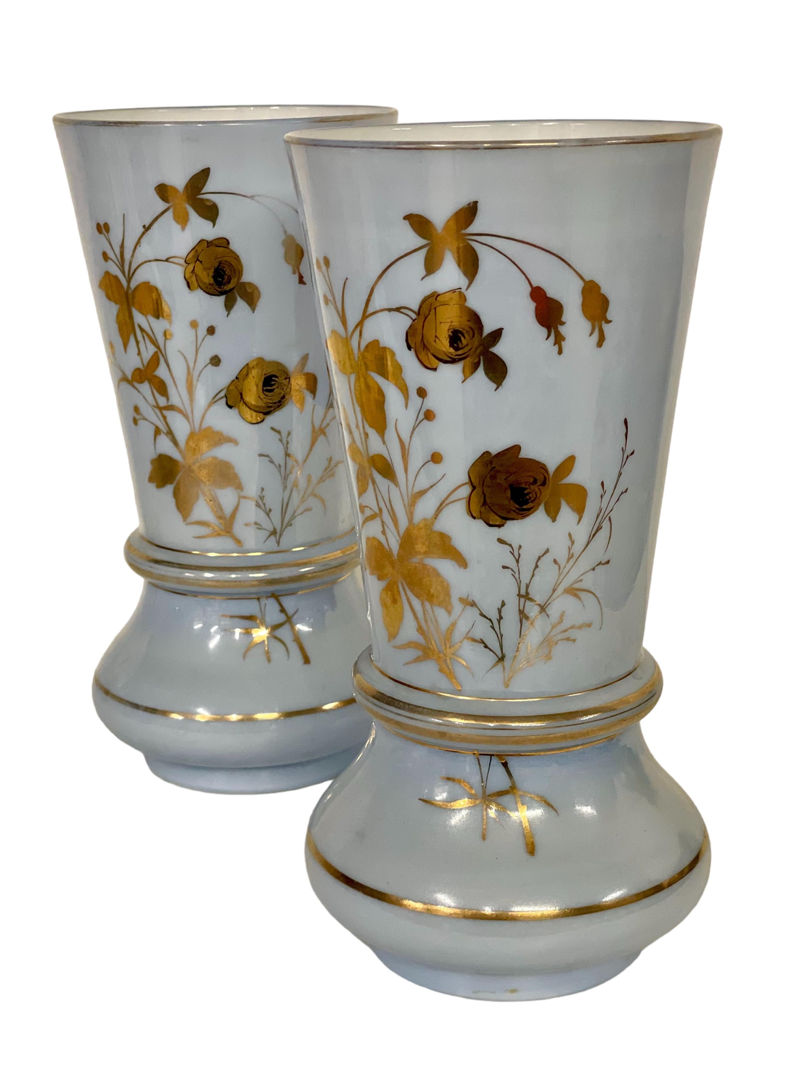 A very delicate pair of palest blue opaline glass vases dating from the mid-19th century (Napoleon III period), each skilfully hand blown and embellished with gilt. These vases have flared bases and rims that have been highlighted with golden bands