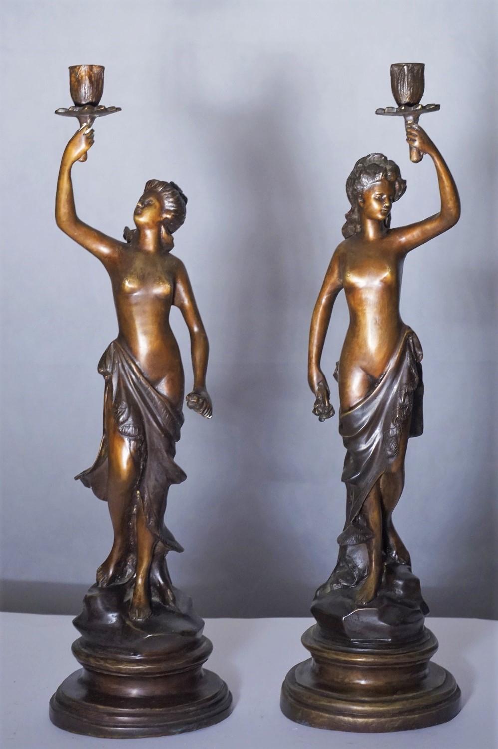 A pair of heavy patinated bronze sculpture candelabra, France mid-19th century. Two female sculptures holding a candleholder raised on a bronze circular base, signed by the artist.
Measures:
Height 21 in / 54 cm
Base diameter 6 in / 15 cm.