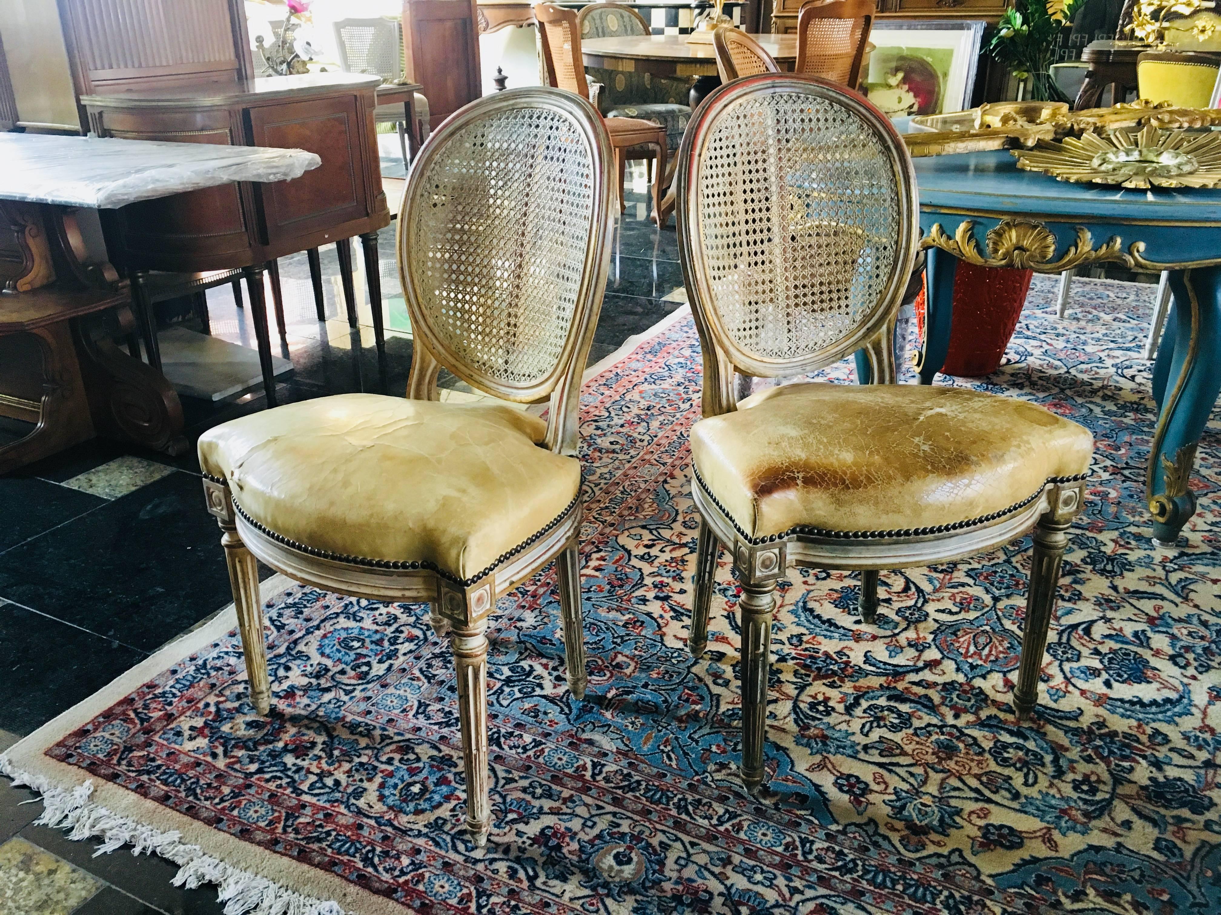 19th century pair of French side chairs with cane backs and original leather seats made of hand-painted wood.
France, circa 1860.
