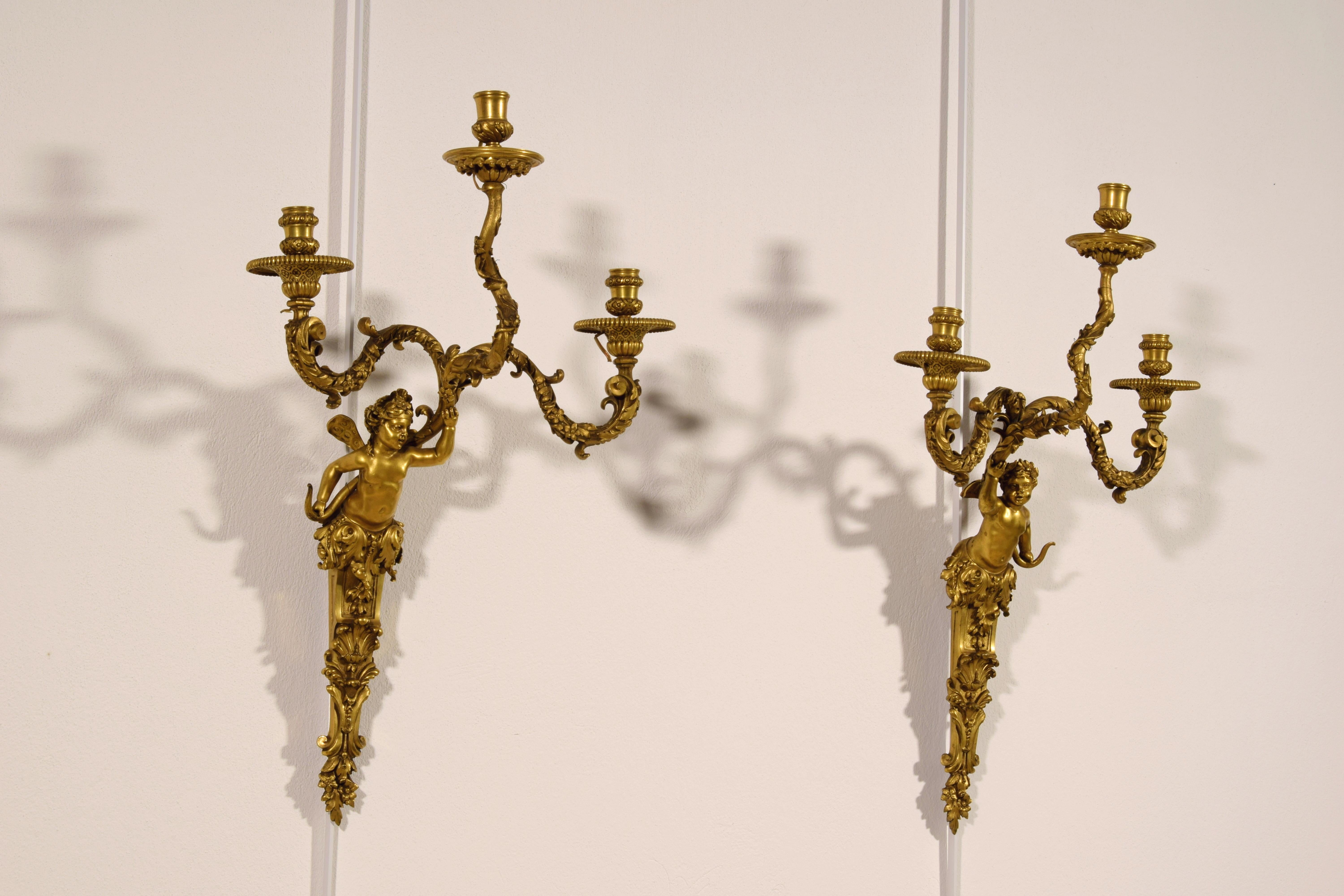 19th century, pair of French three-light gilt bronze appliques

The refined pair of wall lamps was made in France in the 19th century in chiseled and gilded bronze. The quality and design, particularly rare and unusual, is inspired by the styles