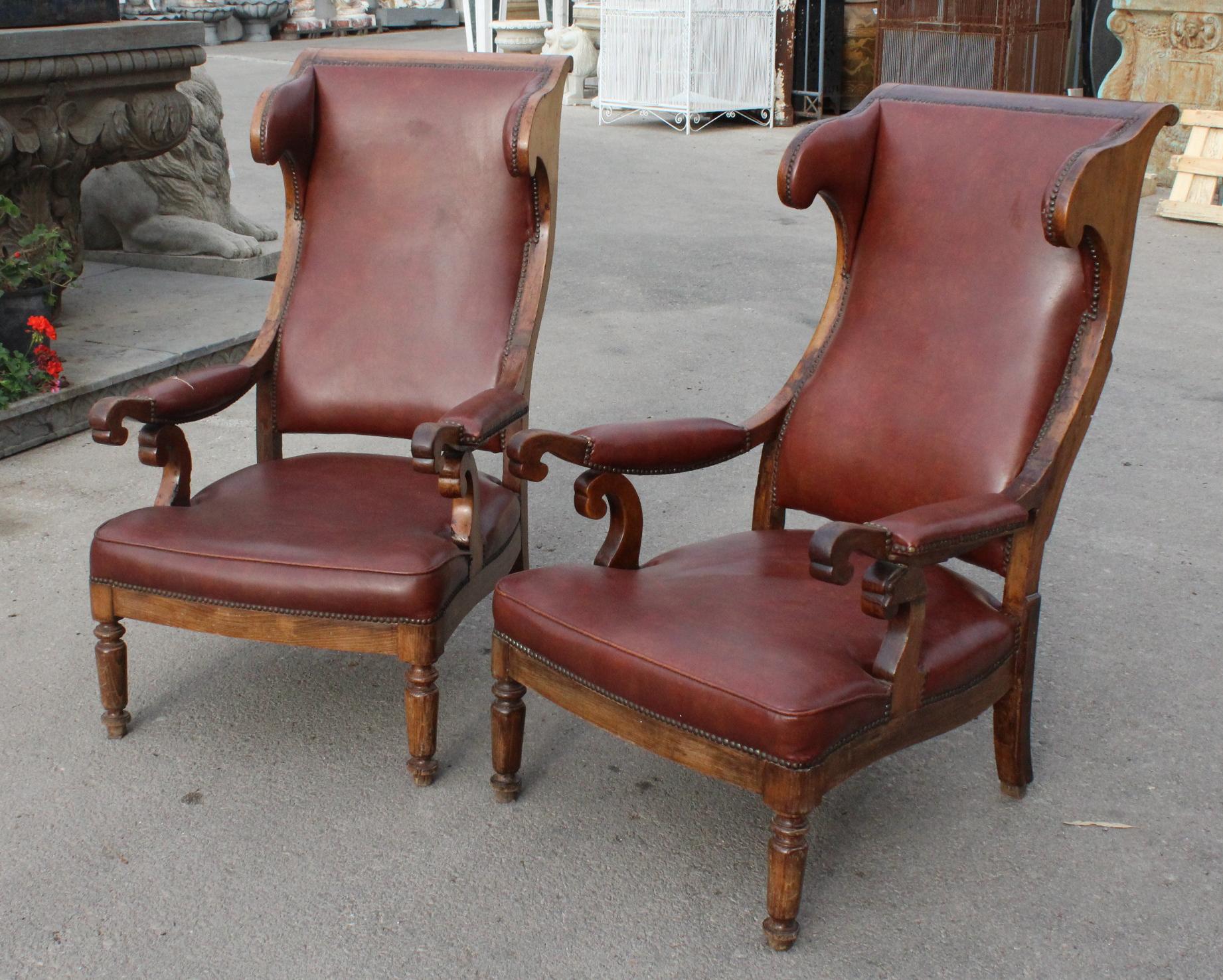 19th century pair of French walnut leatherette upholstered armchairs.