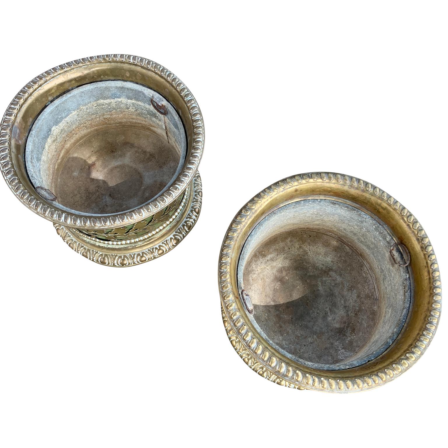 A pair of French brass antique bottle holder coasters from the first part of the 19th Century. With their pierced design around the circumference and the shape of leaves, they are ideal in form as well as functional in size (diameter 6,3 inches - 16