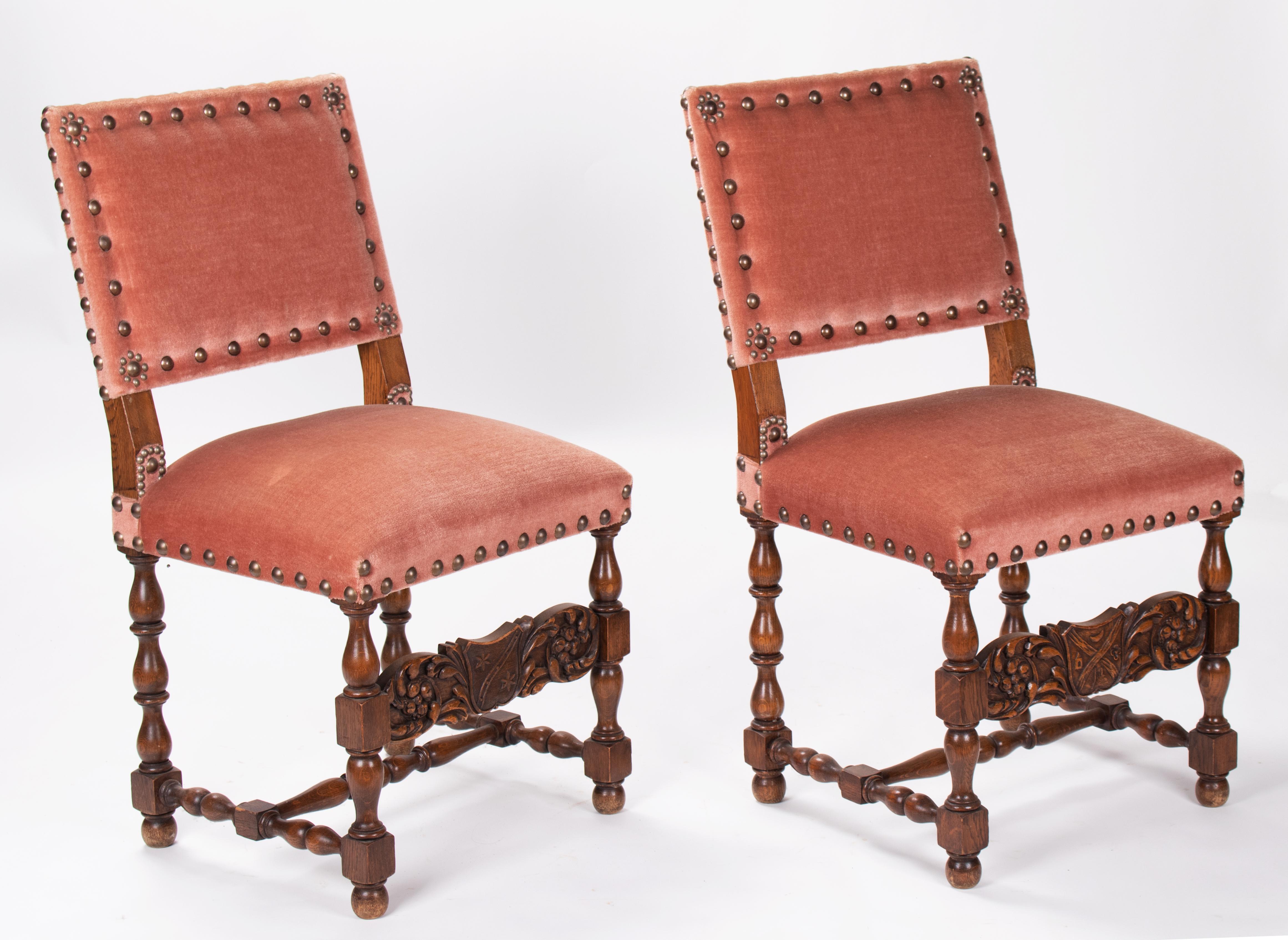 19th century pair of French wooden chairs upholster in velvet with a coat of arms hand carved on the frontal cross beam. 

 
