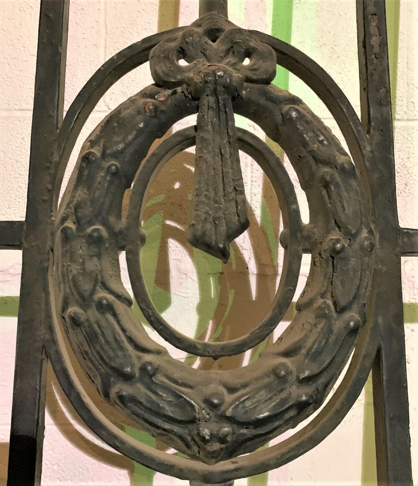 Fabulous large pair of French architectural wrought iron gates featuring fine handcrafted scroll work, textured glass inset panels, and laurel wreaths held by a knotted ribbon. Multiple uses, ready to install;

circa 1880.
