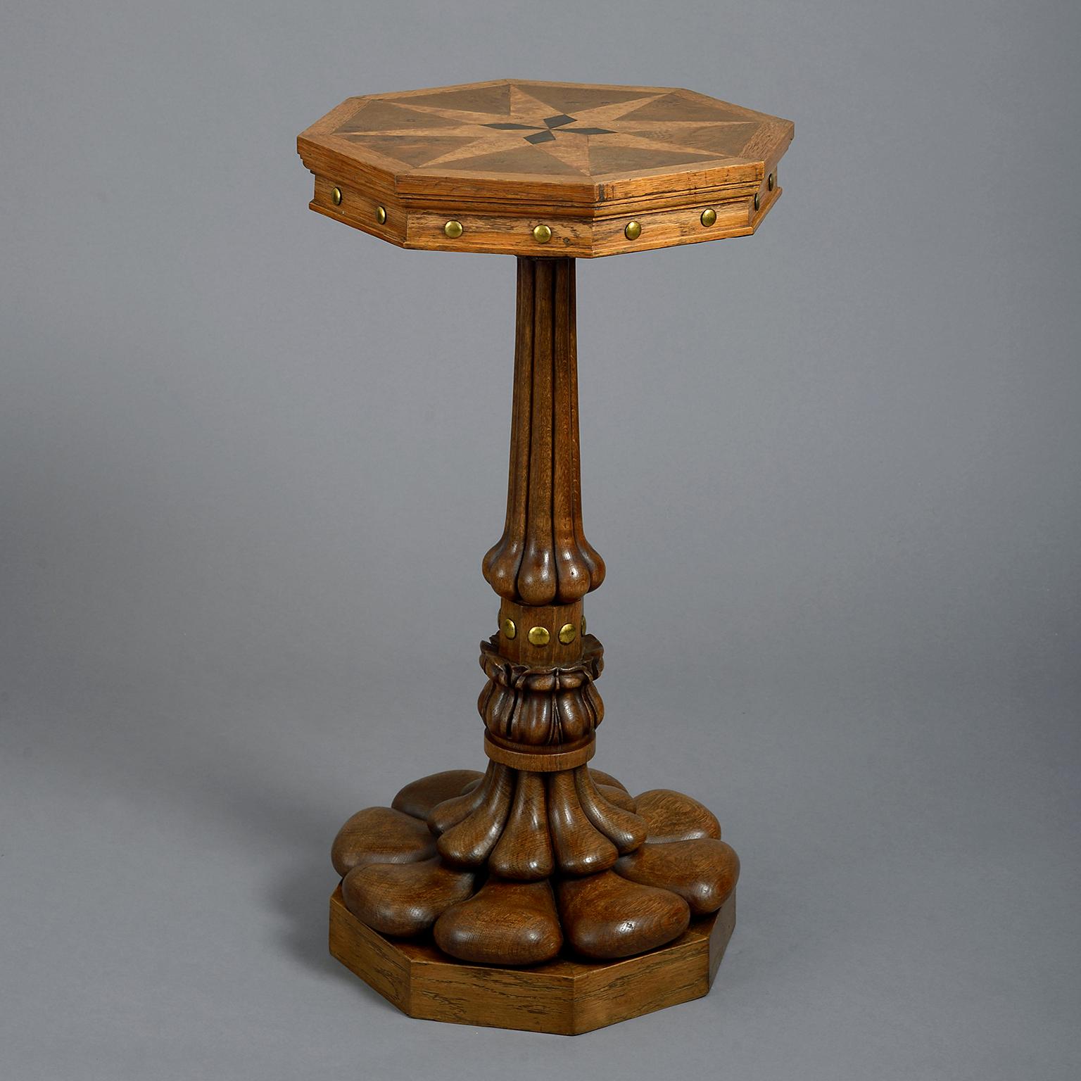A 19th century pair of end tables, the octagonal tops veneered with star-burst against the figured oak ground; above a frieze punctuated with gilt-brass cabachon; raised on highly unusual cluster columns with stylised lotus bases standing on