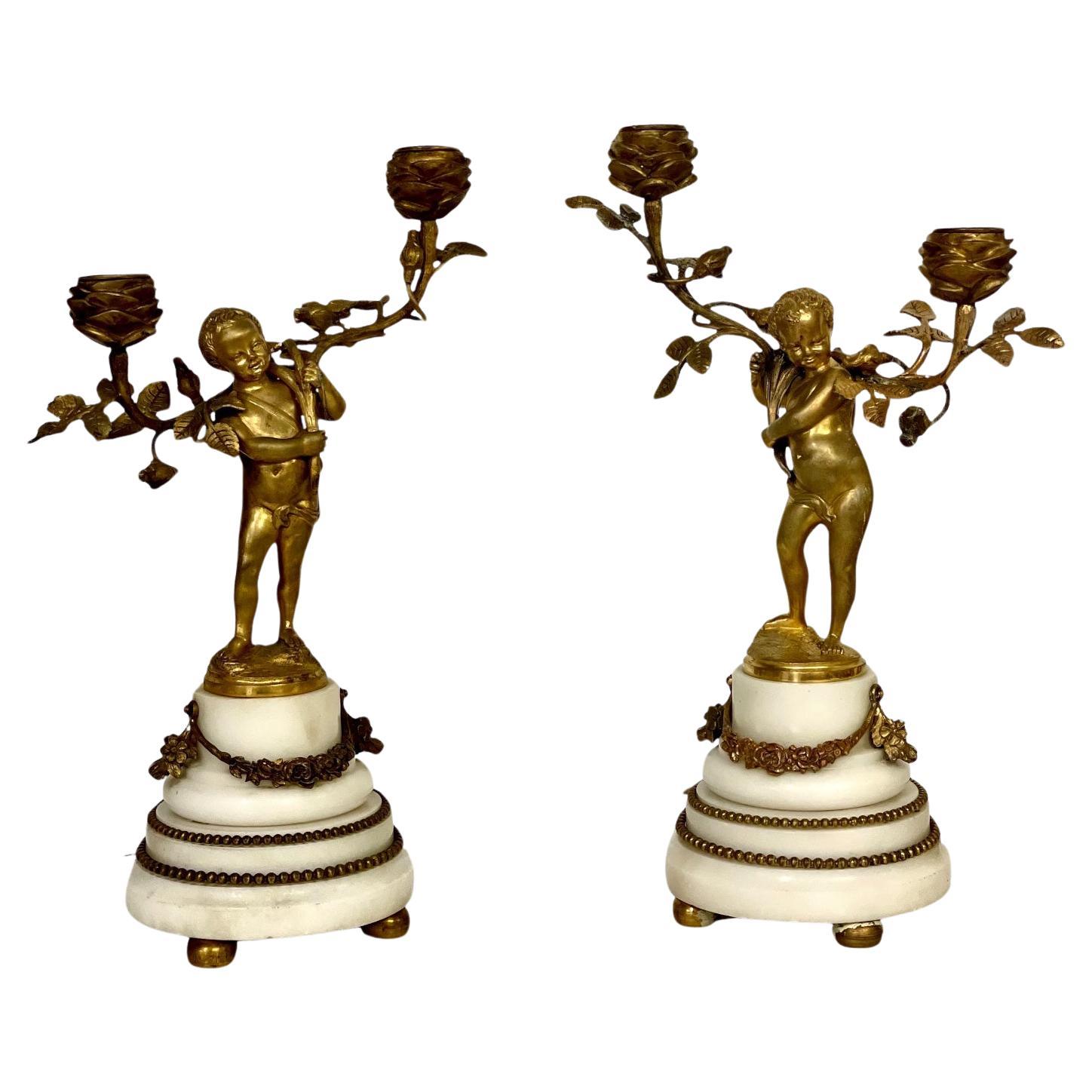 19th Century Pair of Gilt Bronze Cherubs Candelabra on White Marble Stands For Sale