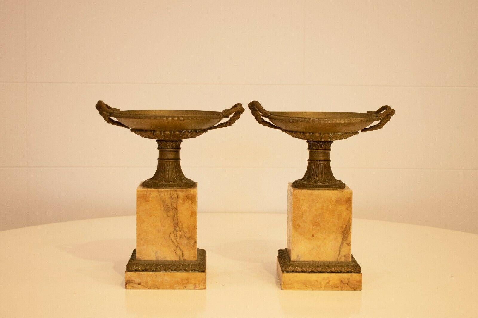 19th century pair of grand tour marble and bronze tazza, of neo-classical design.

Set upon a grand Sienna with marble base, with finely chased lappet cast mounts over a stepped base.

The bronze classical shaped shallows urns feature serpent