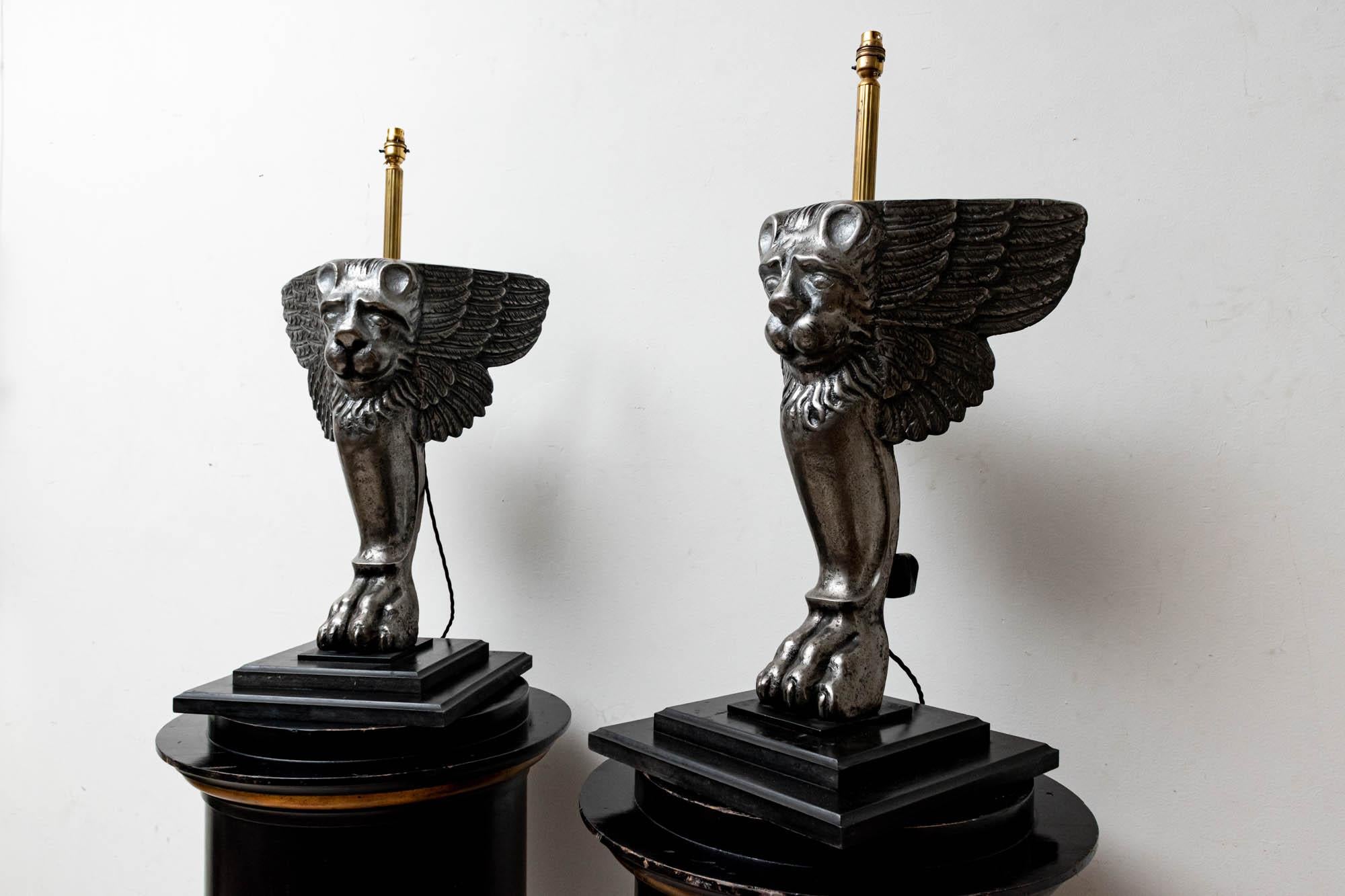 19th century pair of Italian cast iron griffin 'Winged Lion' table lamps which have been converted professionally to lights in the workshop, and mounted on stepped ebonised bases. The Lion of Venice is an ancient symbol which has come to symbolize