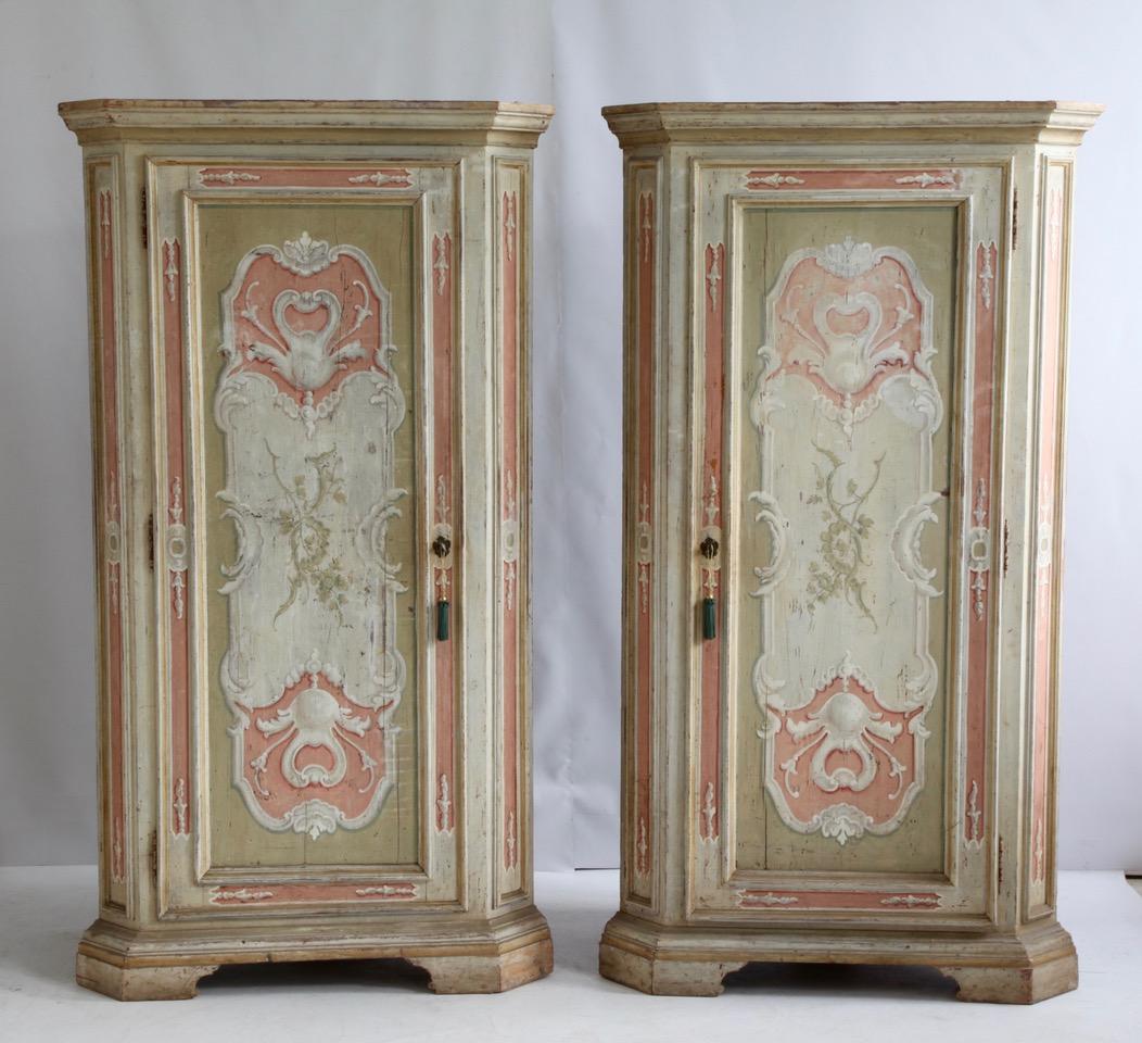 Very beautifully pair of Italian, 19th century, corner cabinets with their original expressive, Italian paintwork in the lively palette of shell pinks and warm greys and with white highlighting. Each cabinet has three shelves. The interiors have