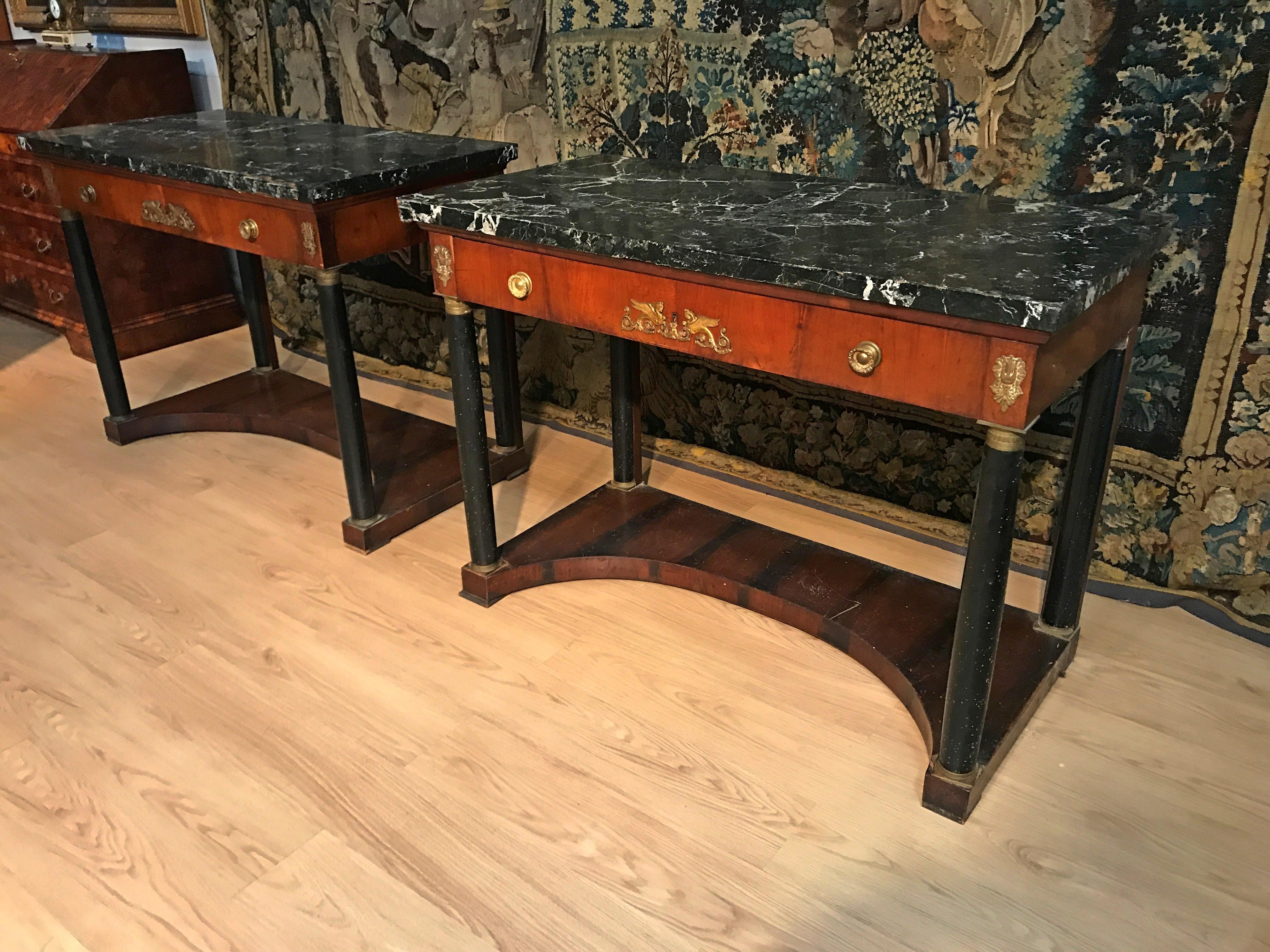 19th century pair of Italian Empire Console with black marble tops 

This elegant pair of Empire consoles was made in the 18th century in Tuscany (Italy). The consoles have a marble top of great value, plated in Aquitania black marble (from the