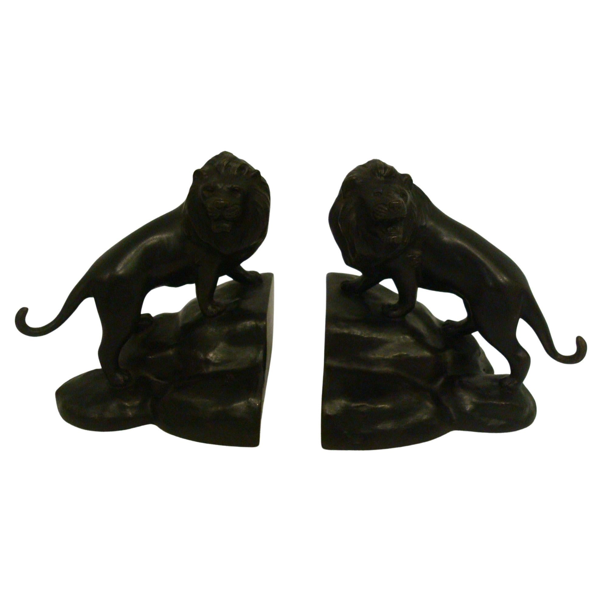 This superb and rare pair of Japanese Meiji period bronze bookends are cast in solid bronze and depict a pair of Lions, with their heads raised. These finely sculpted pieces are beautifully finished with great detail to the hair texture. When