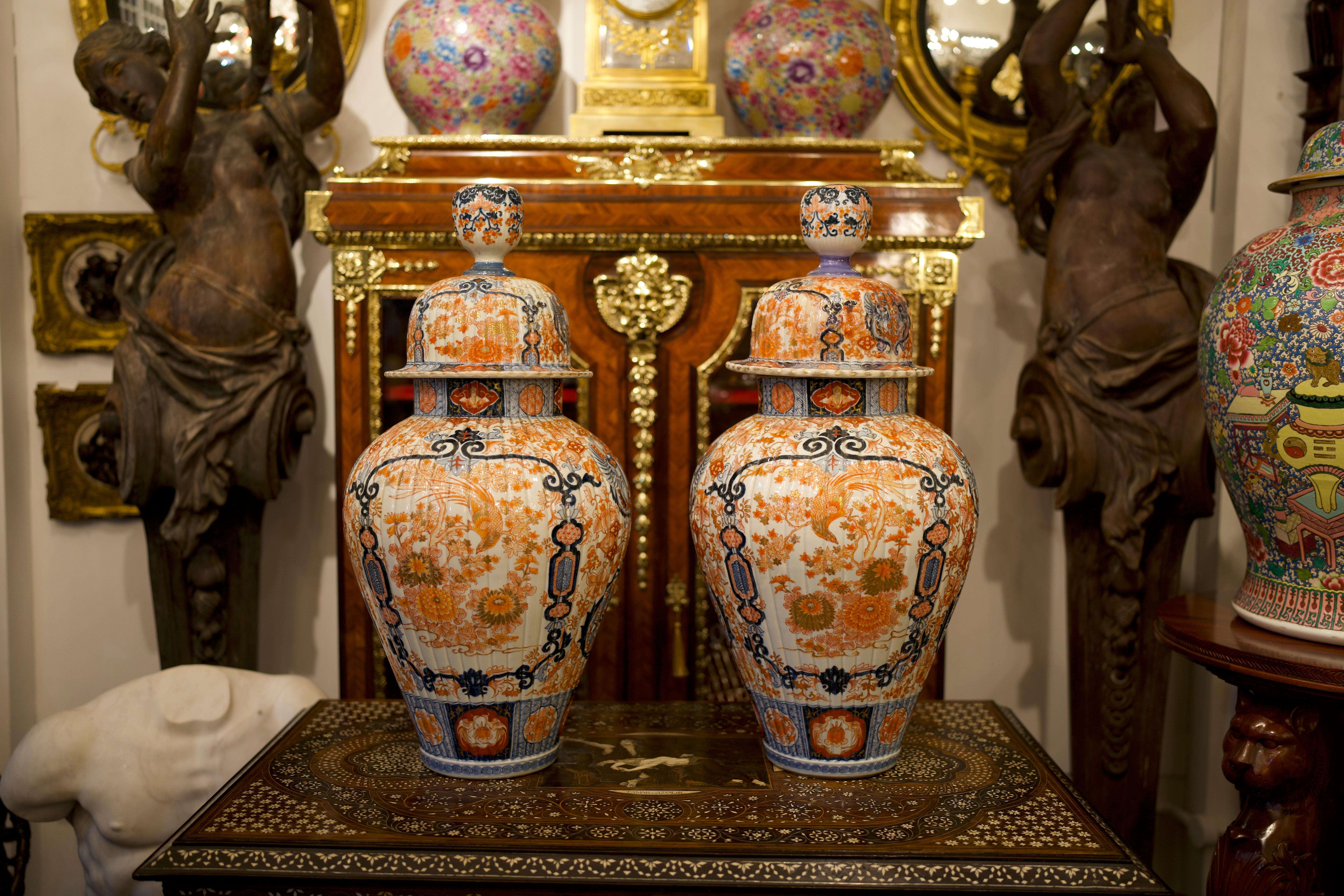A beautiful 19th century Pair of Japanese Imari Lidded Ginger Jars/Vases.

This highly decorative and fine pair of Japanese Imari ginger jars depict a central outdoor ceremonial scene surrounded by colourful geometric and floral patterned designs.