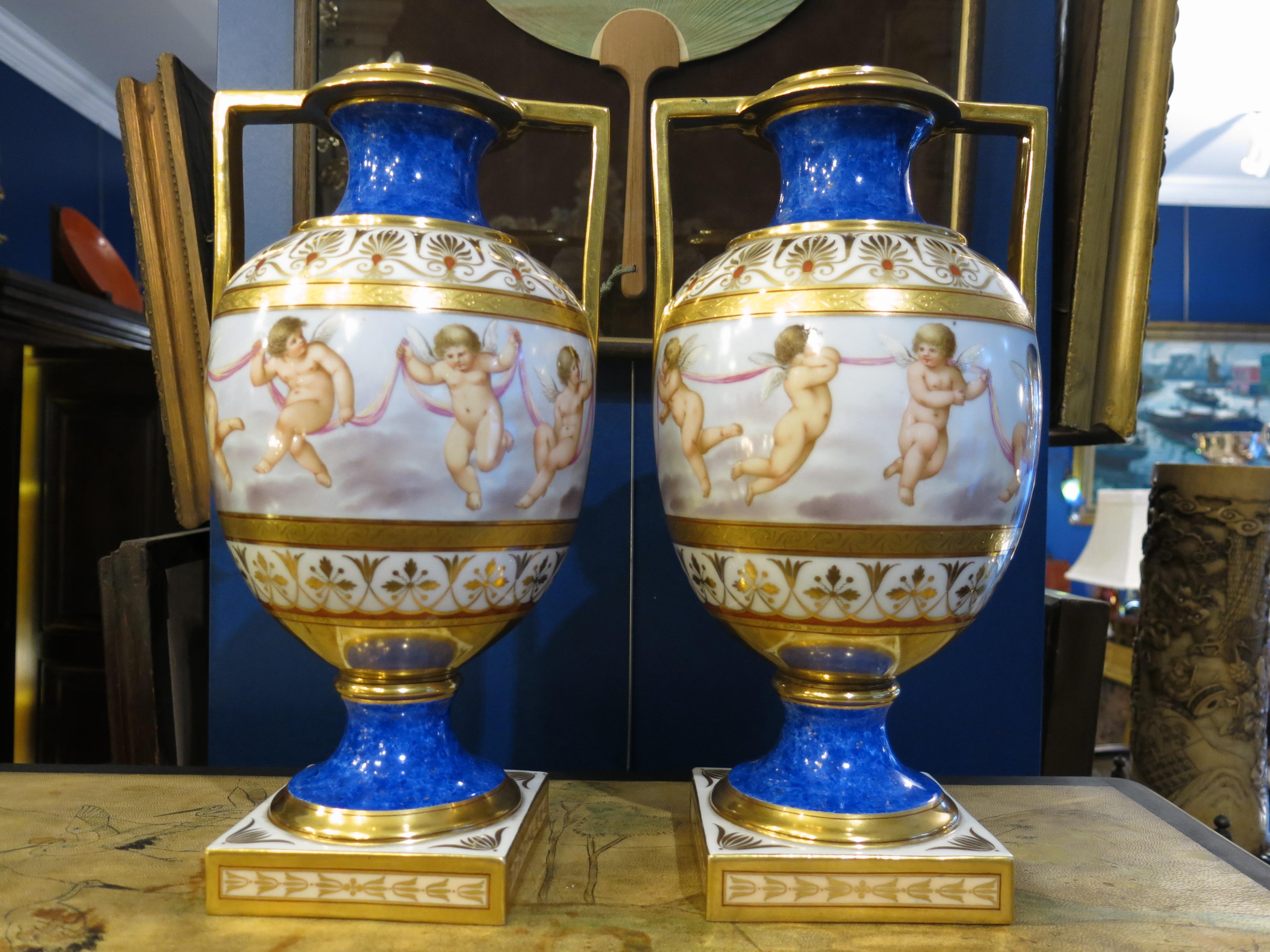 Neoclassical style for this pair of KPM porcelain vases in blue and gold colors with florals and querubines motifs. Signed under the base. Very good condition.
We export worldwide.