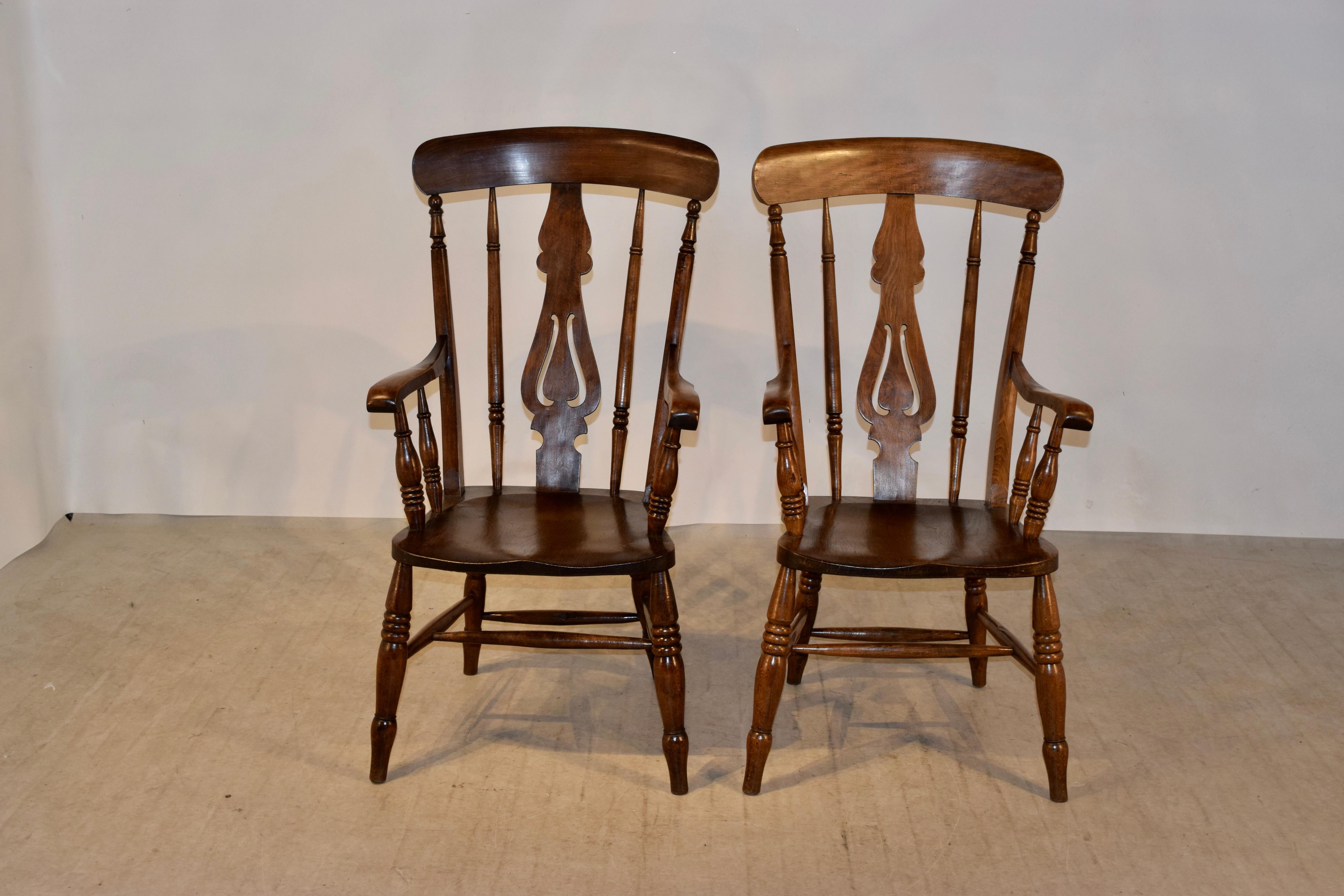 19th century pair of ladder back armchairs from the Lancashire region of England. They are made from oak and elm and are wonderfully comfortable. The have hand turned spindles in the backs flanking pierced vase slats, supported on hand turned legs