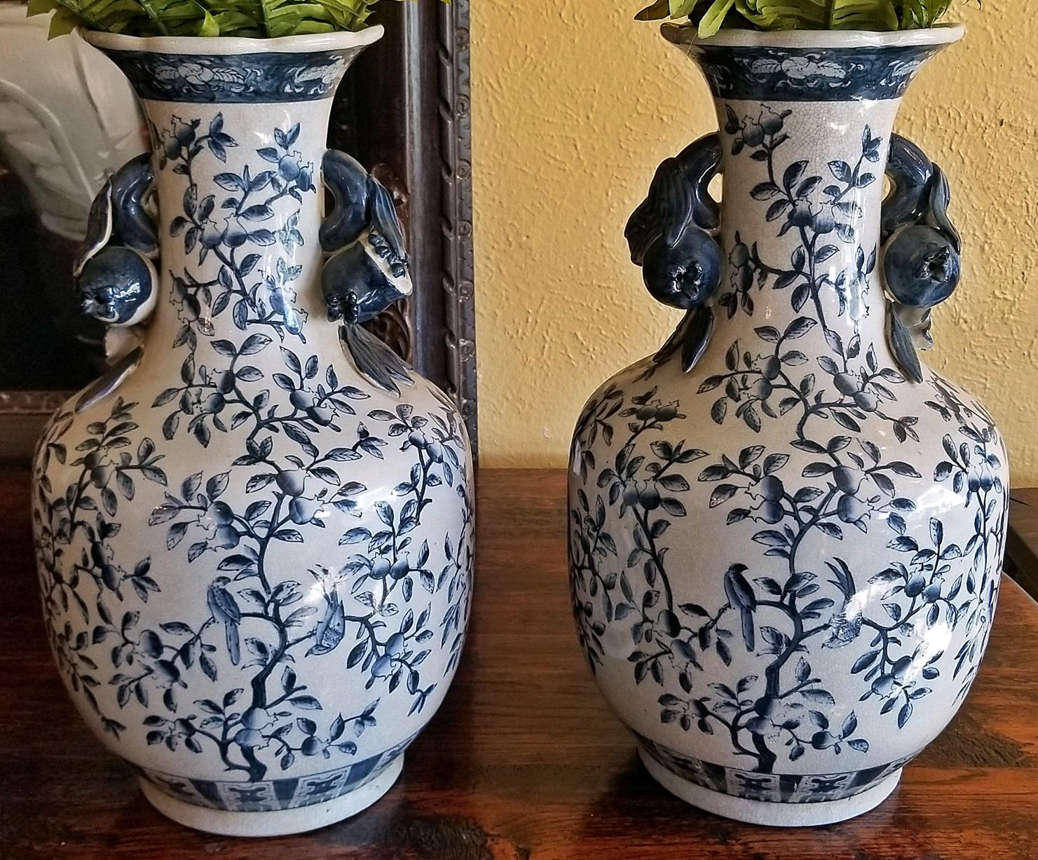 Nice pair of large 19th century ironstone blue and white floor vases made in Staffordshire, Britain in the Chinese style.

Trailing foliage with birds on each.

Large tulip style handles on each.

Natural crazing indicates age.

Made circa
