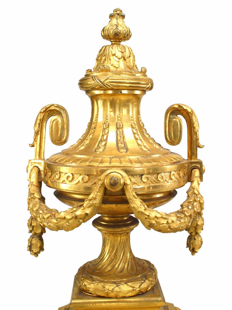 Pair of French Louis XVI-style (19th Century) bronze dore urn and festoon andirons with small urn at one end with ring handles. (PRICED AS PAIR).
 