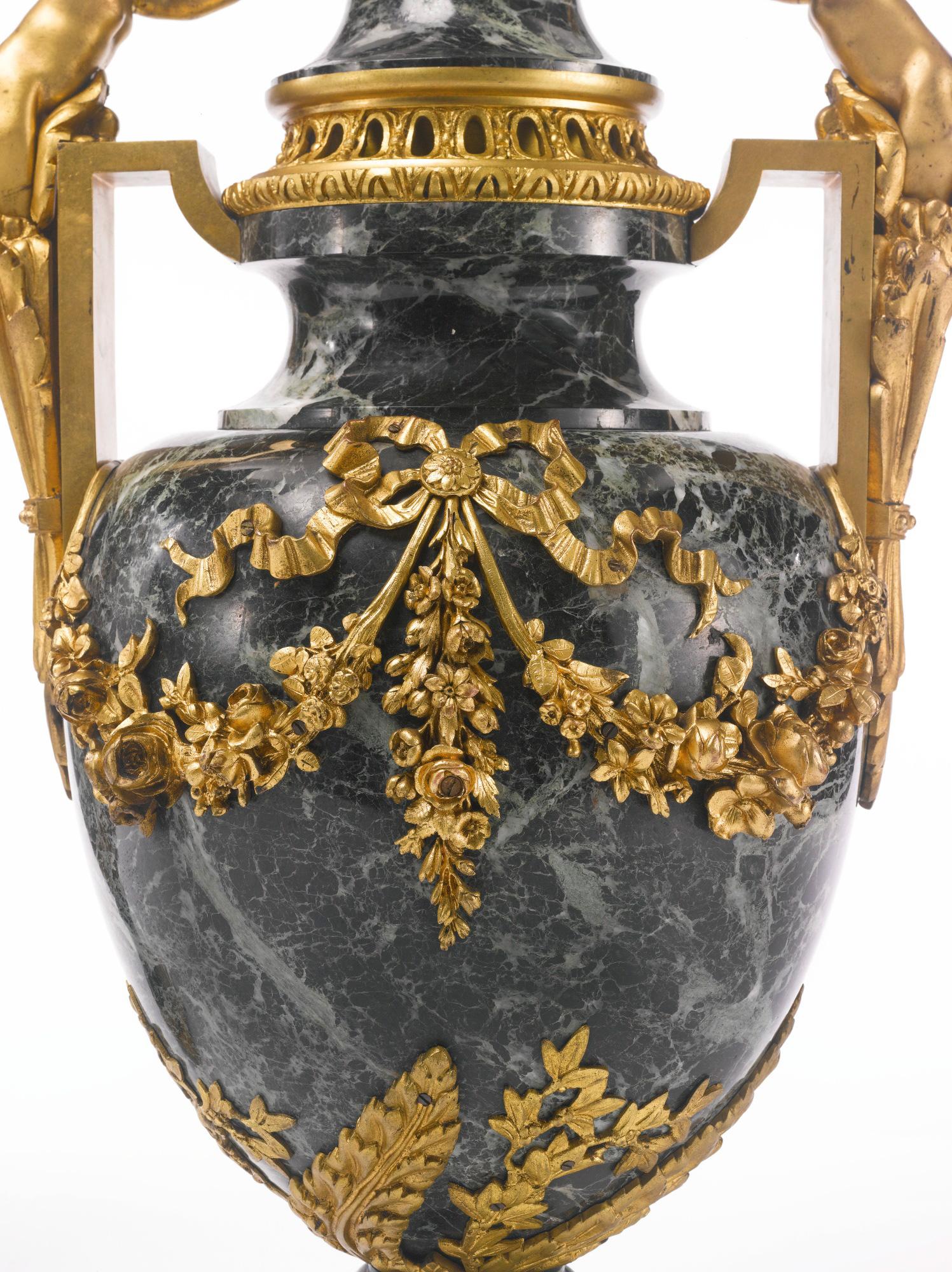 A large pair of Late 19th century Louis XVI style gilt-bronze mounted Patricia green marble urns

Origin: France 
Date: late 19th century
Size: height 28 1/2 inches high