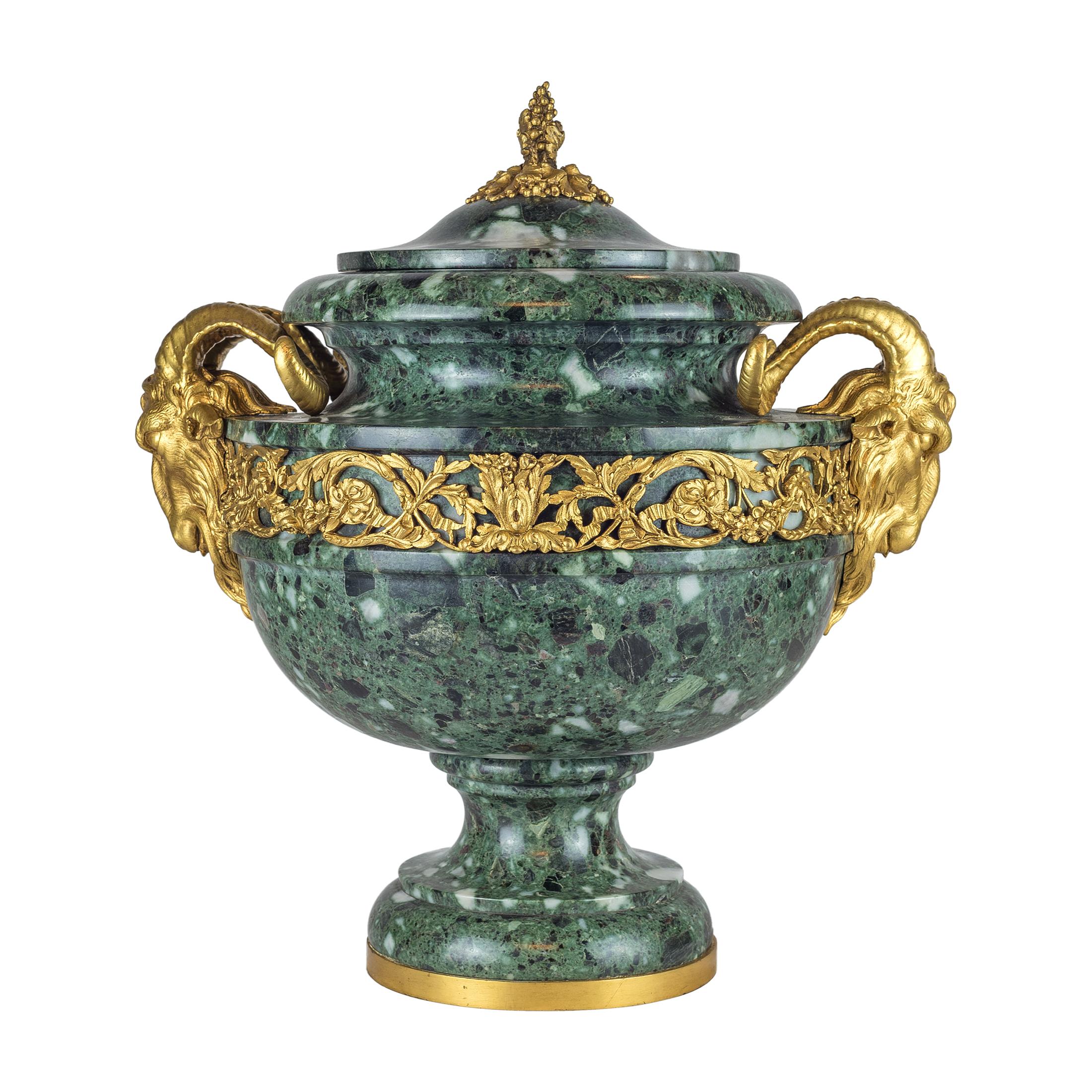 A Very Special Pair of Louis XVI Style Ormolu Mounted Verde Antico Marble Urns and Cover.
Each with grape finials. The handles formed ram’s head, raised upon a waisted sole and dome circular base. 

Origin: French?Date: 19th century?Dimension: 15