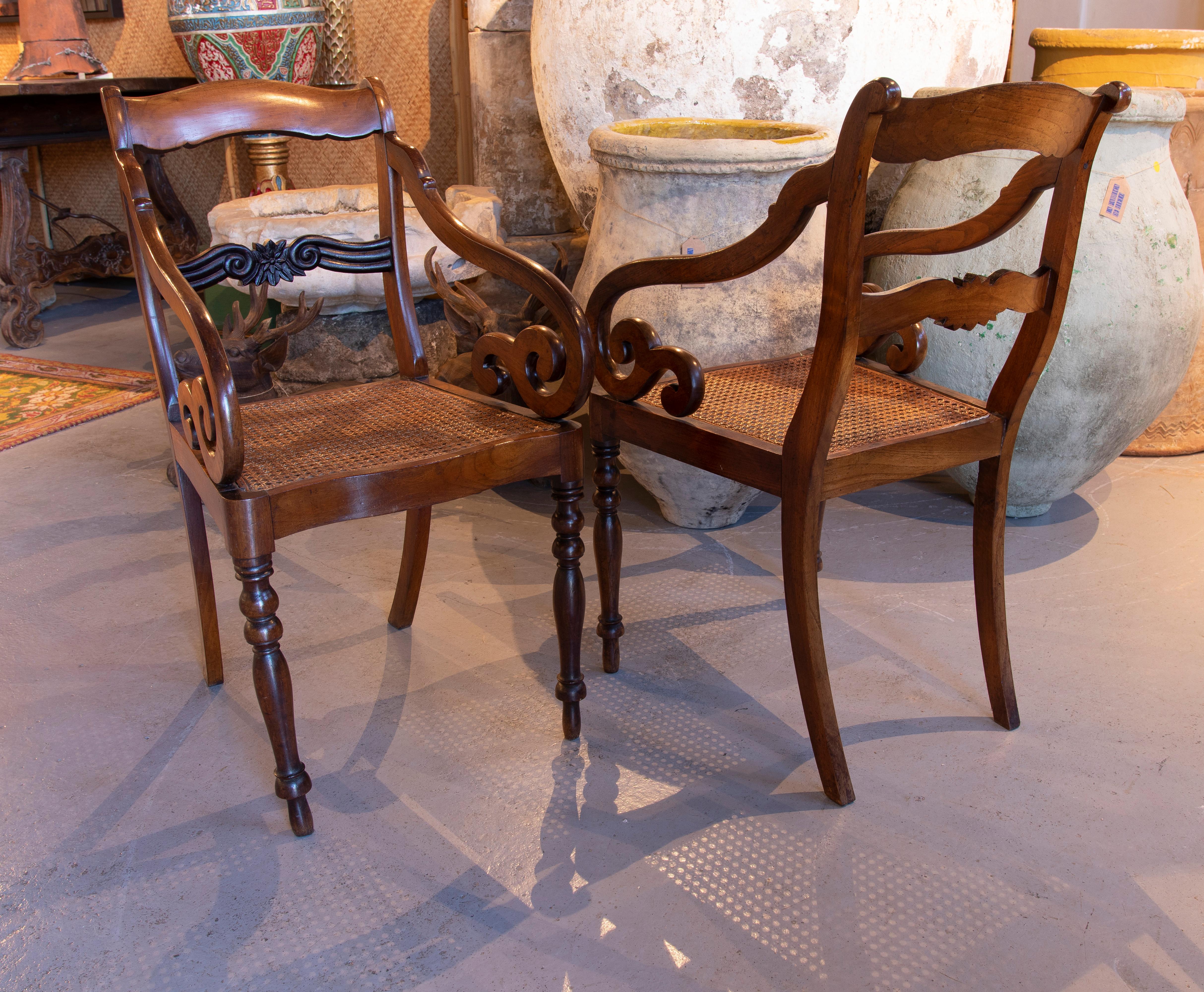 19th century Pair of mahogany armchairs with wickerwork seats.