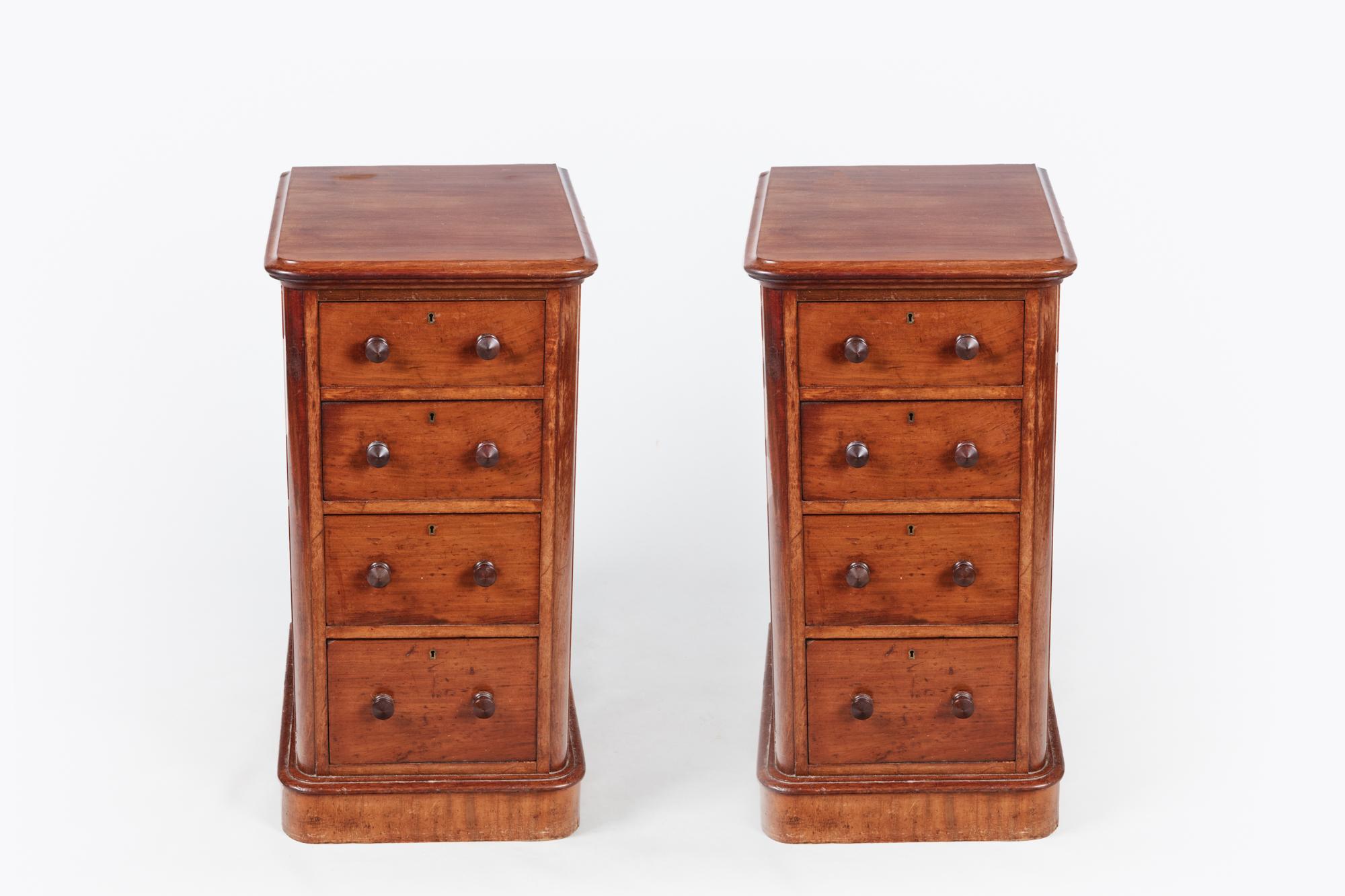 19th century pair of mahogany bedside lockers, the moulded top raised over four graduated drawers with two mahogany pulls and brass escutcheon terminating on moulded plinth base.