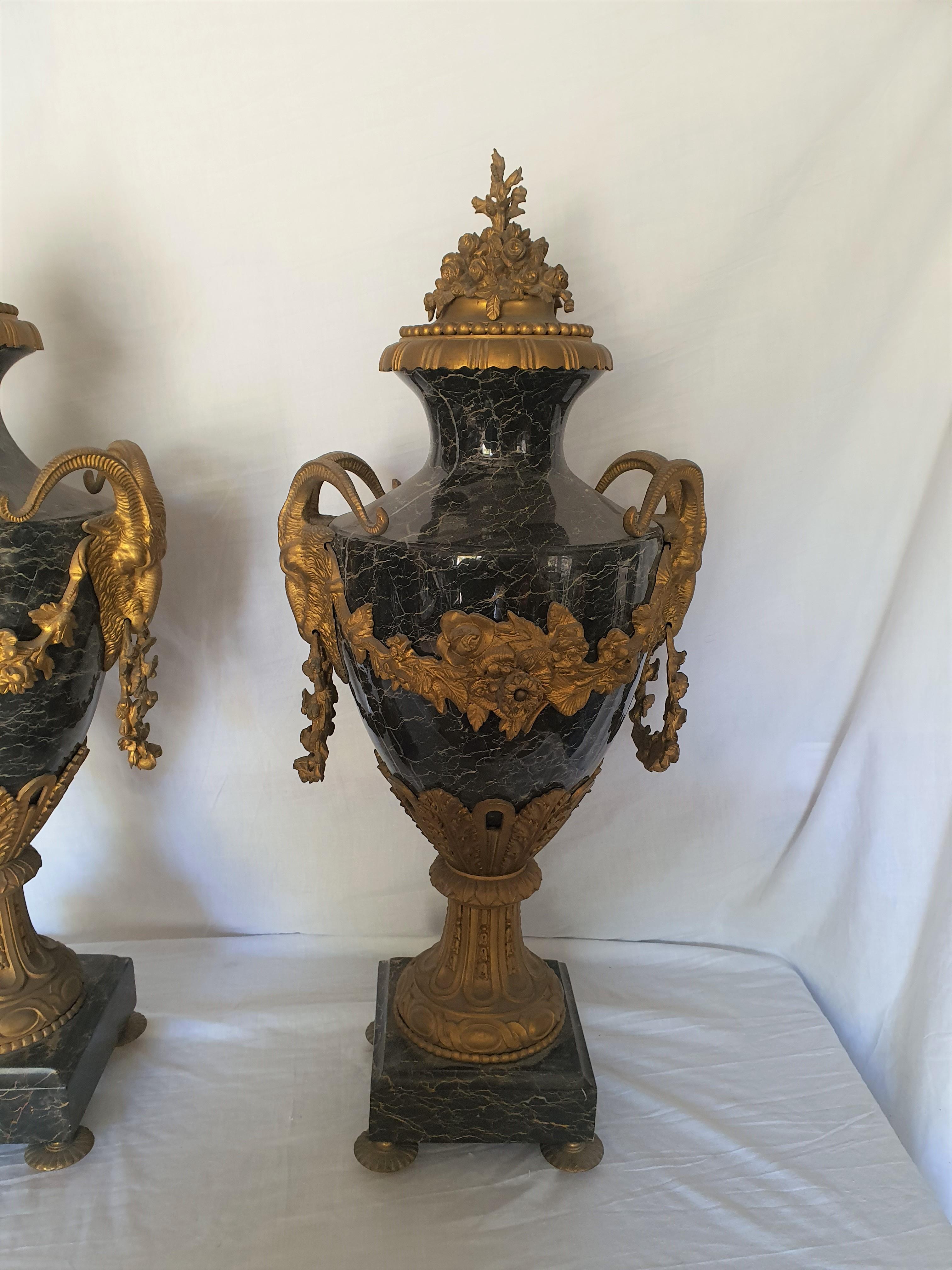 Elegant pair of marble vases, with applications in finely chiseled and gilded bronze. Goat heads, finely chiseled, support the side handles. Particular workmanship in the upper part, finely chiseled and gilded bronze with a floral motif.