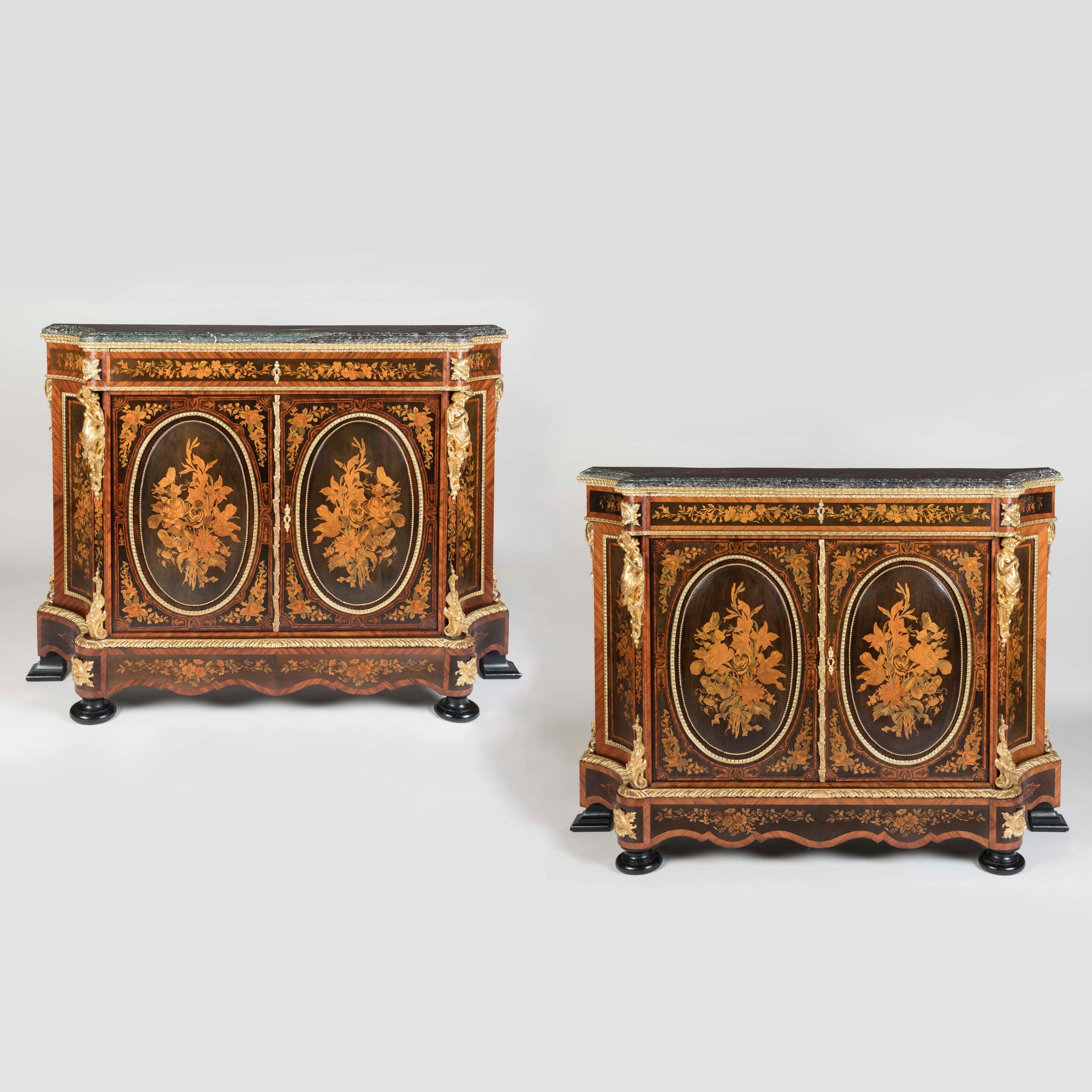 A Striking Pair of Napoleon III  Meubles d'Appui
The Marquetry attributed to Joseph Cremer

Constructed from tulipwood with inlay of various specimen woods including harewood, fruitwood, ashwood and boxwood, ormolu mounted throughout, the shaped