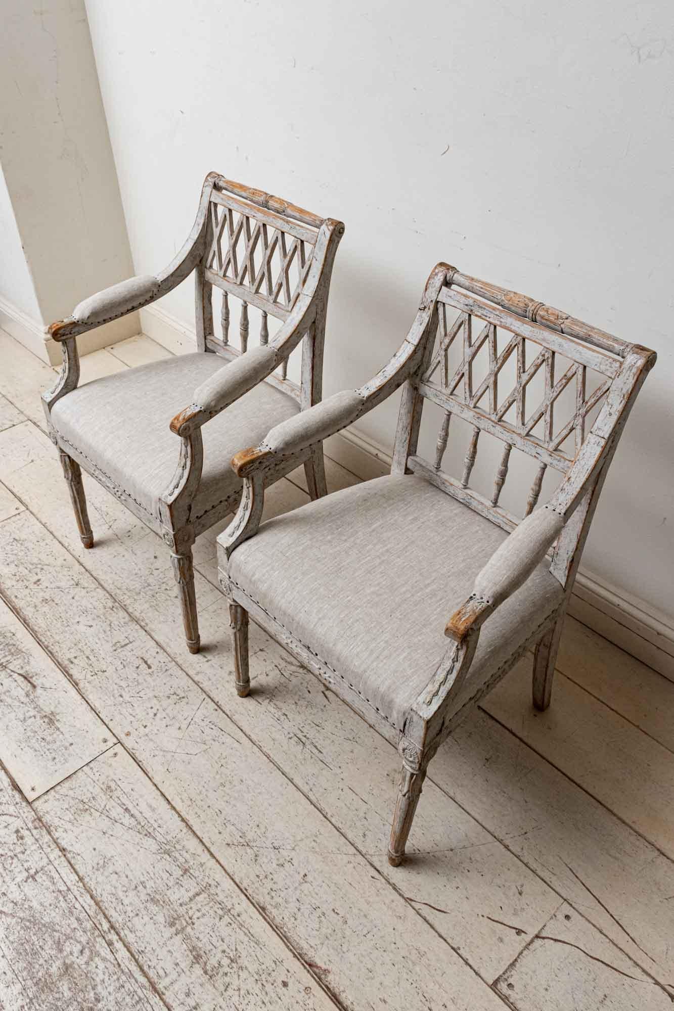 Charming pair of Swedish 19th century painted chairs.
Lattice backs.
Rosette detail on the front.
Small in size yet comfortable and roomy.
Reupholstered simply in a neutral linen.
Refreshed paint
These chairs would make a lovely addition to