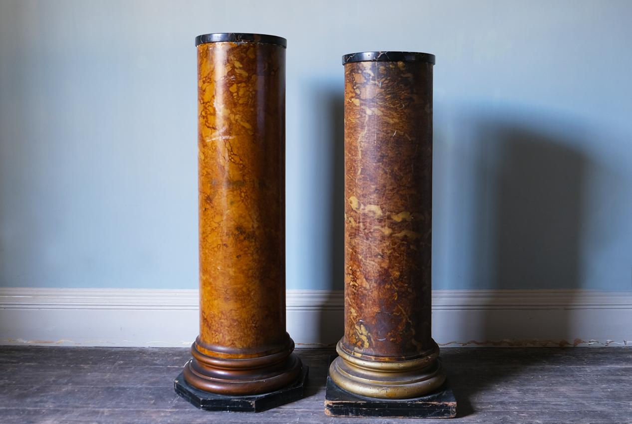 A pair of 19th century Regency scagliola simulated Siena marble column pedestals with a stepped base and plinth. 

Dimensions: H125 x D44 & H119 x D44 cm
