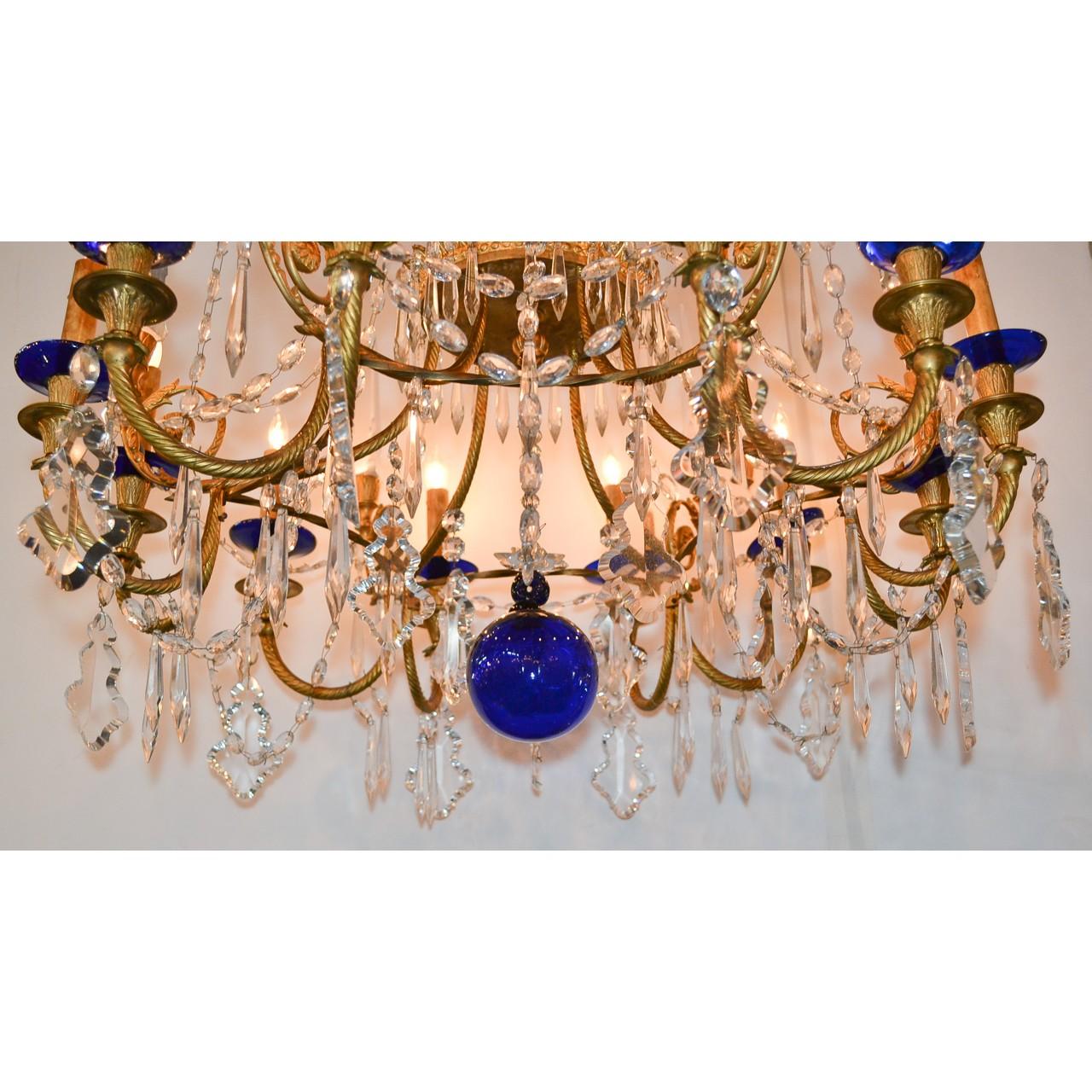Rare and very fine pair of 19th century Russian chandeliers of gold-gilded bronze, cut crystal, and cobalt blue glass. The bronze leaf scroll and rosette crown adorned with faceted bead, diamond, and spear cut crystals. The stem with gorgeous cobalt
