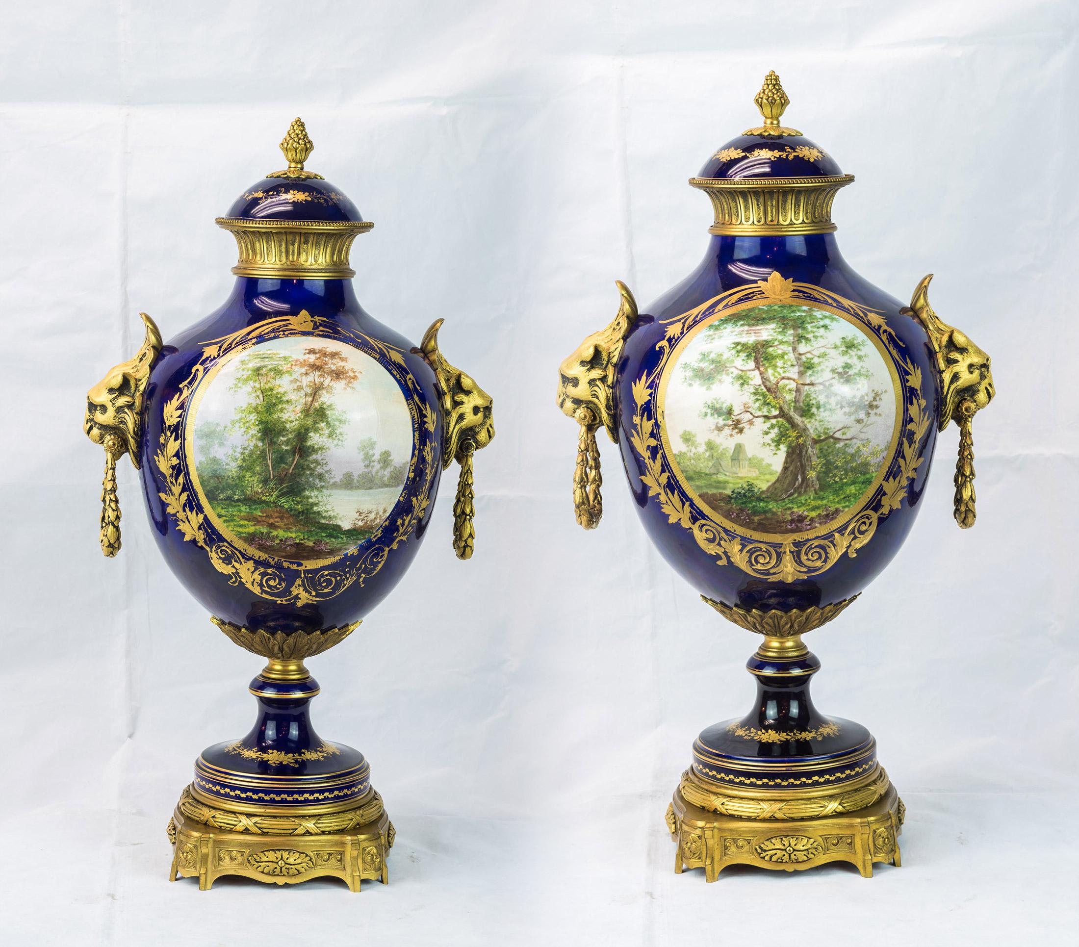 An exquisite pair of Sèvres style ormolu-mounted, cobalt blue, porcelain vases with lion mask handles, hand painted mythological scenes to the front.

Date: circa 1880
Origin: French
Dimension: 24 in. x 13 in.