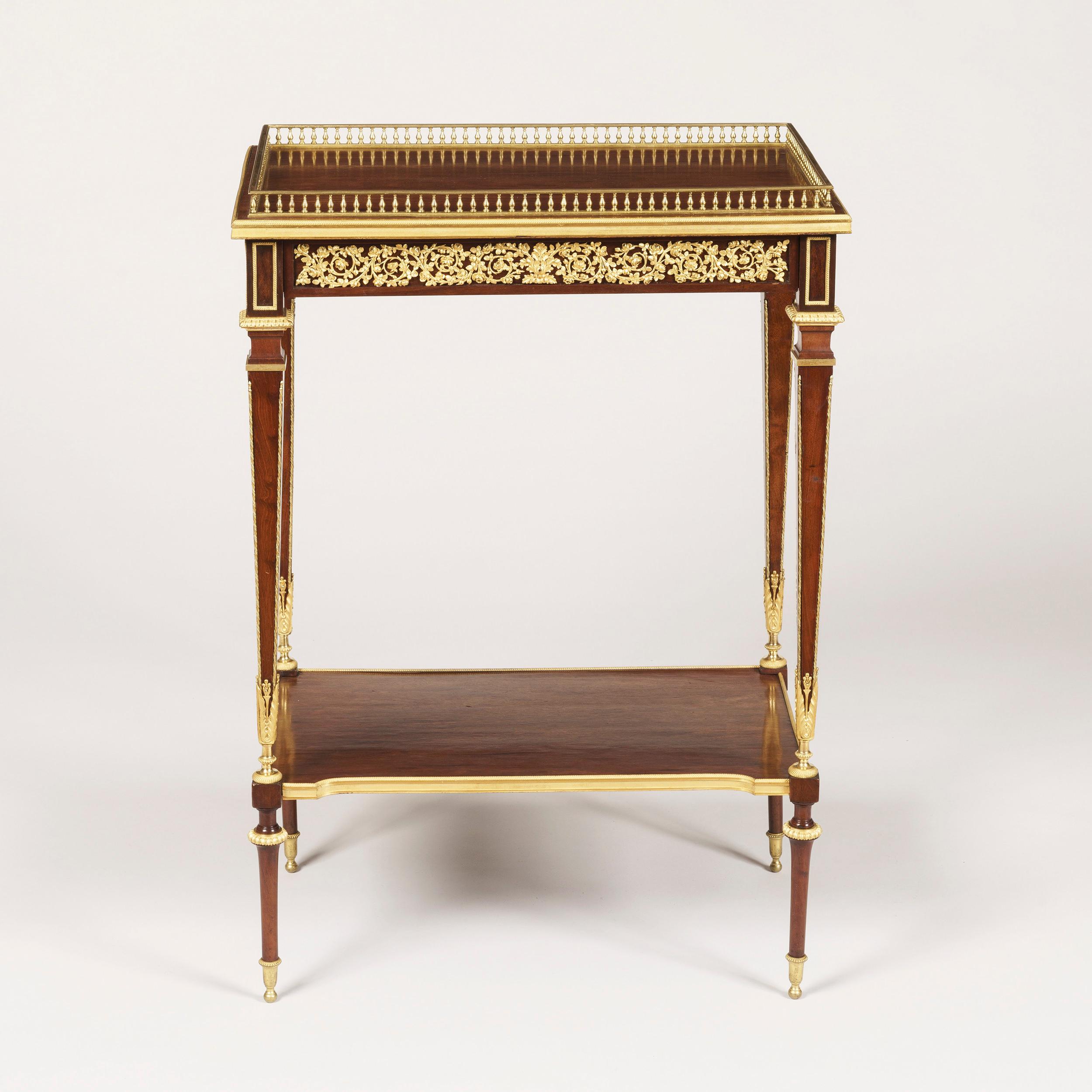A matched pair of side tables in the Louis XVIth manner
by Paul Sormani

Of rectangular form constructed in mahogany, with gilt bronze ormolu enrichments; rising from truncated conical legs adorned with ormolu sabots, the lower tiers of incurved