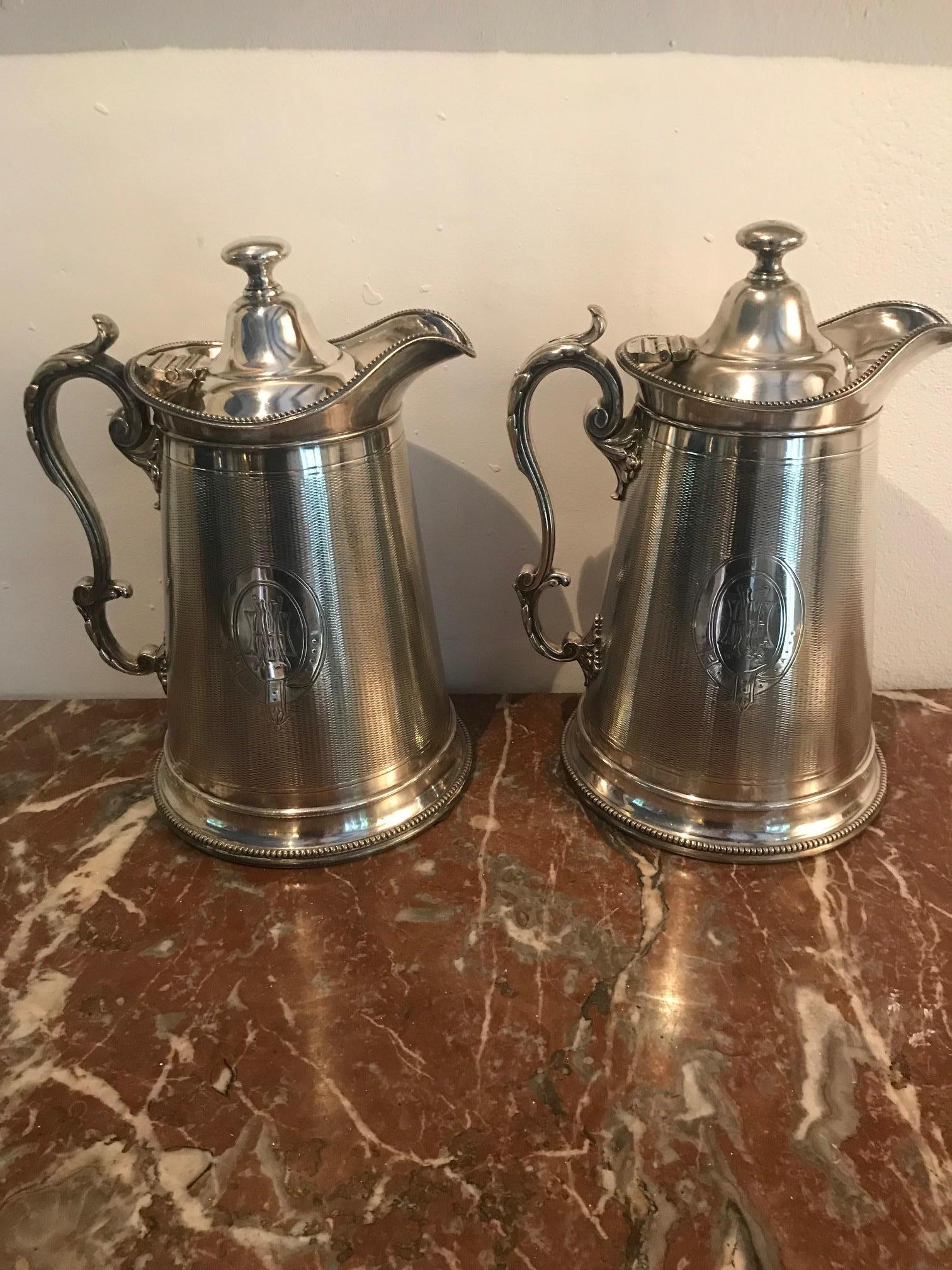 A wonderful pair of silver plate water jugs/ pitchers by Carringtons of Regent Street London. Showing delicate, detailed engraving.
