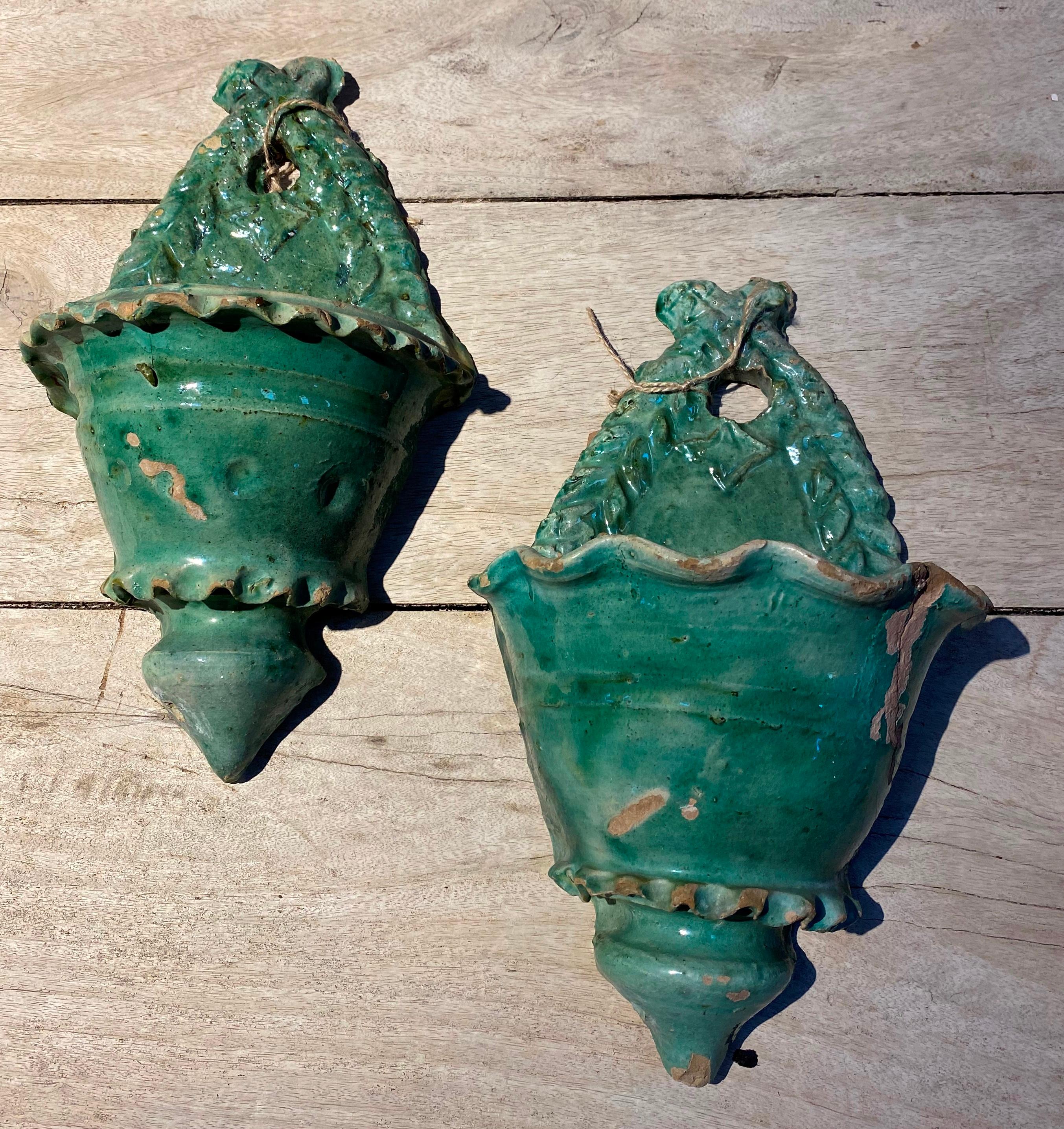 19th century pair of Spanish green glazed ceramic wall hanging planters.