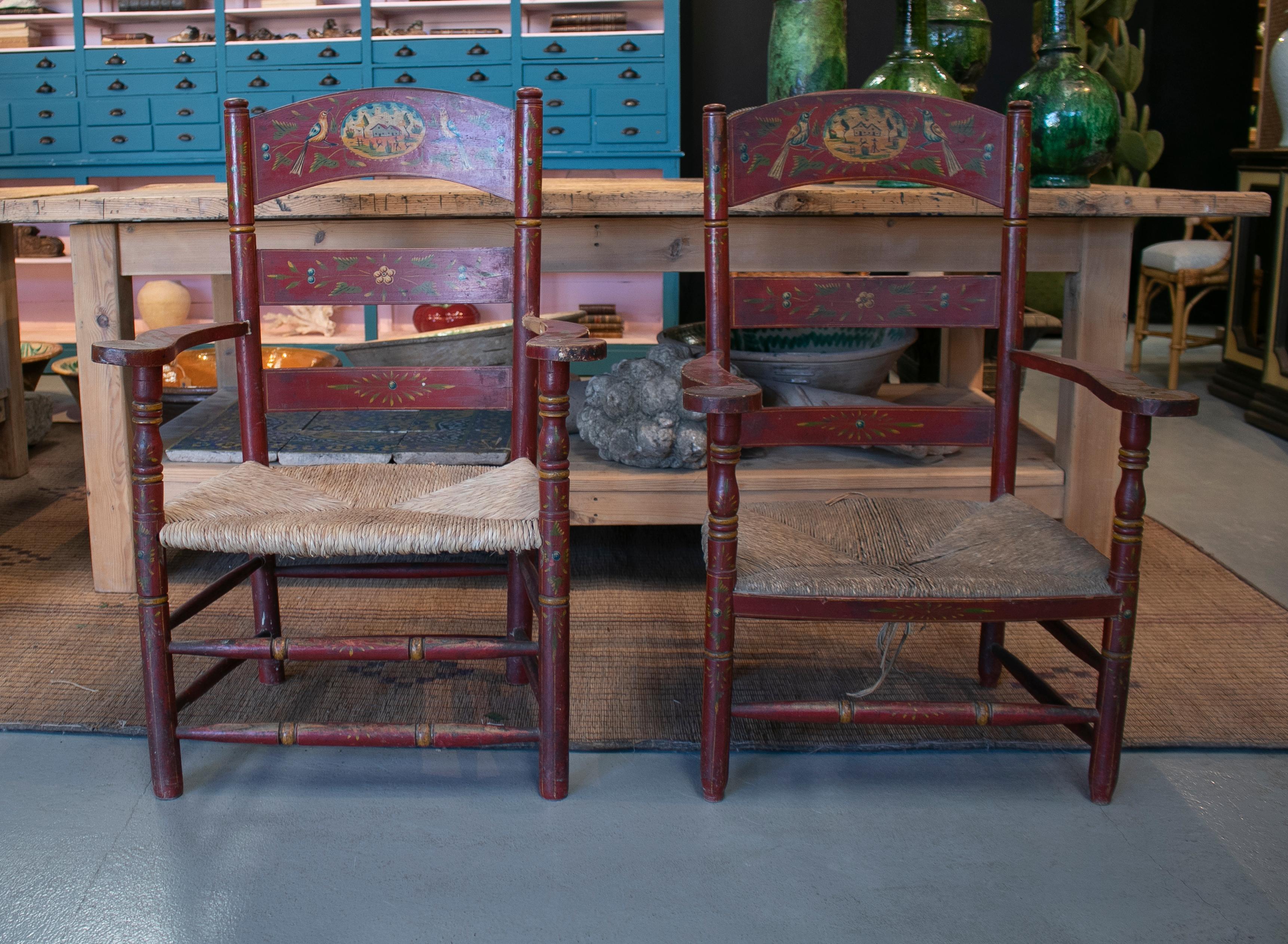 19th century pair of Spanish hand decorated rope bottomed wooden armchairs.