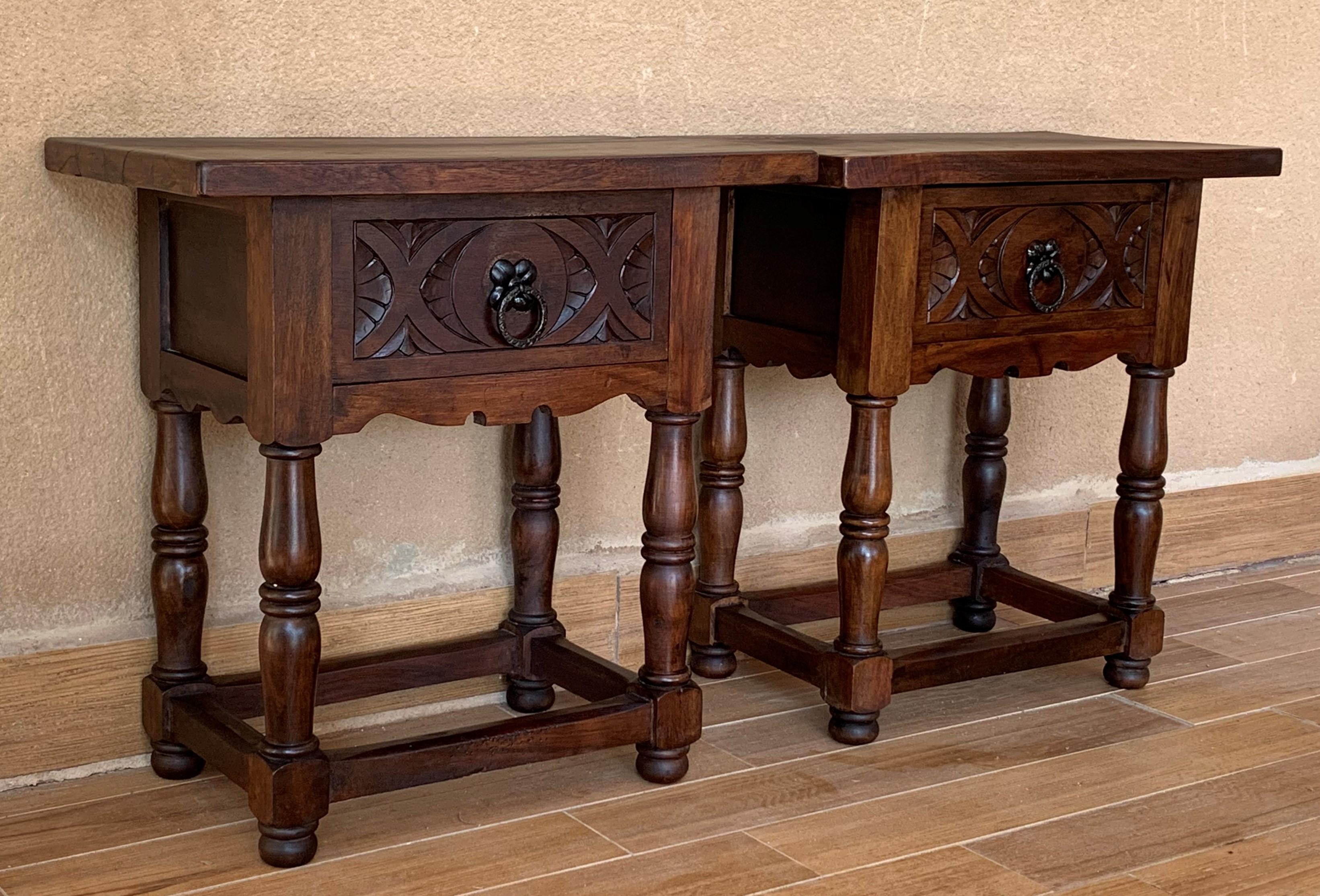 19th century pair of Spanish nightstands in solid walnut with carved drawer and iron hardware.
Beautiful tables that you can use like a nightstands or side tables, end tables, or table lamp.